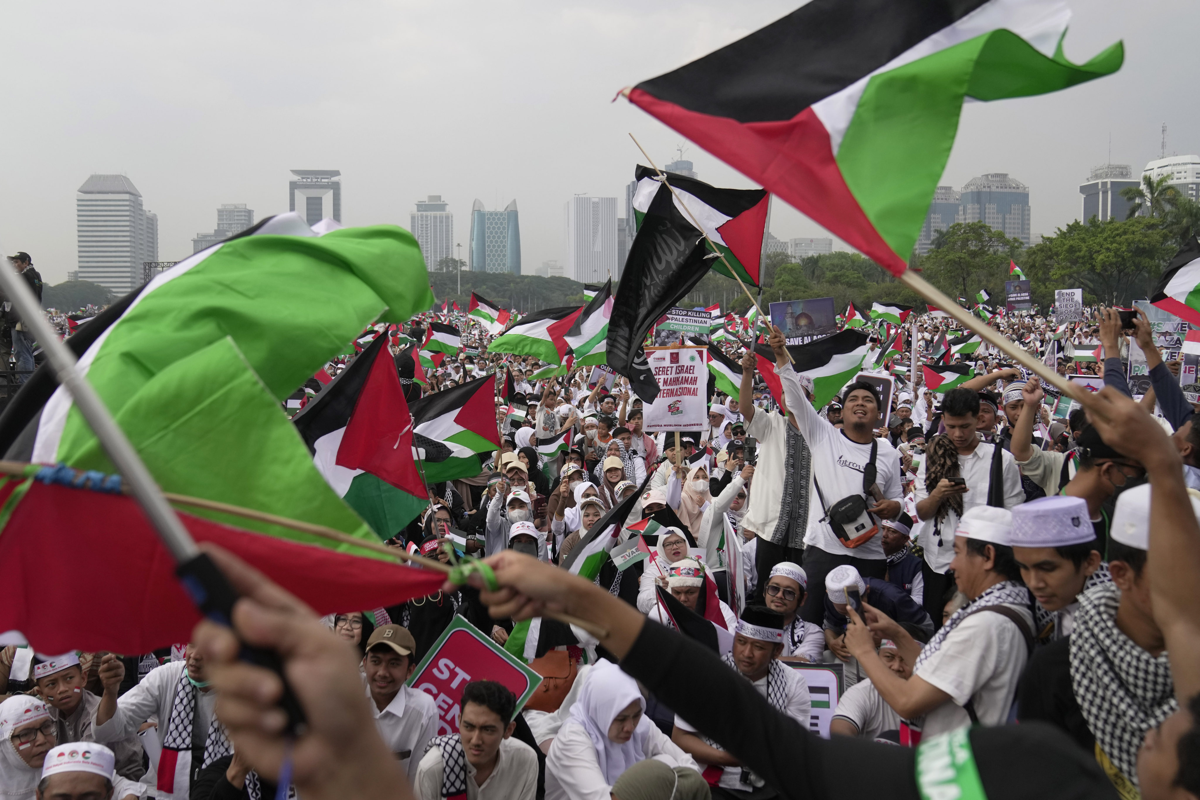 Protesters shout slogans and wave Palestinian flags during a rally in Jakarta on Sunday. Photo: AP