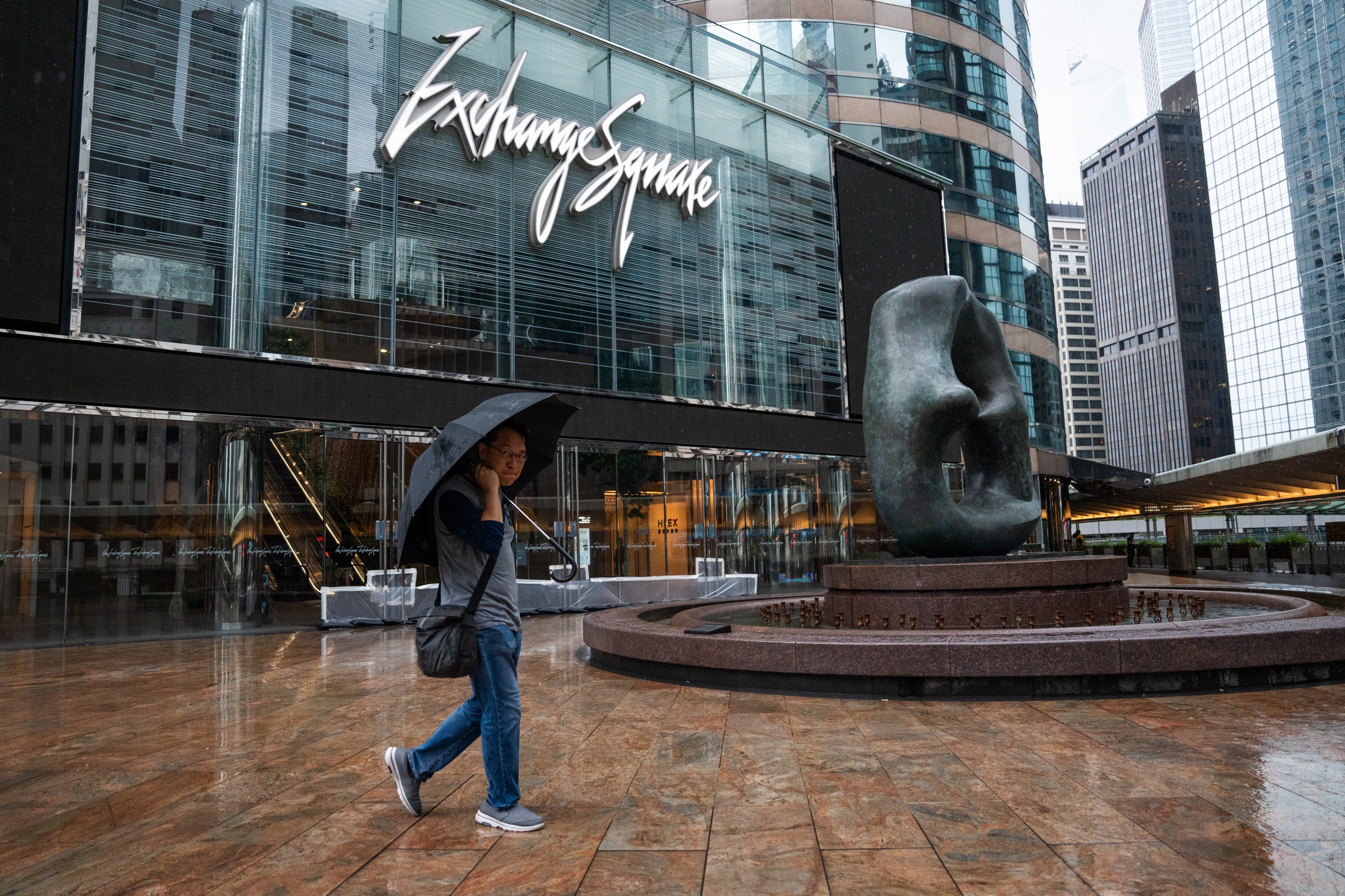 A man walks past the Exchange Square in Central during Typhoon Saola on September 1, 2023. Photo: EPA-EFE