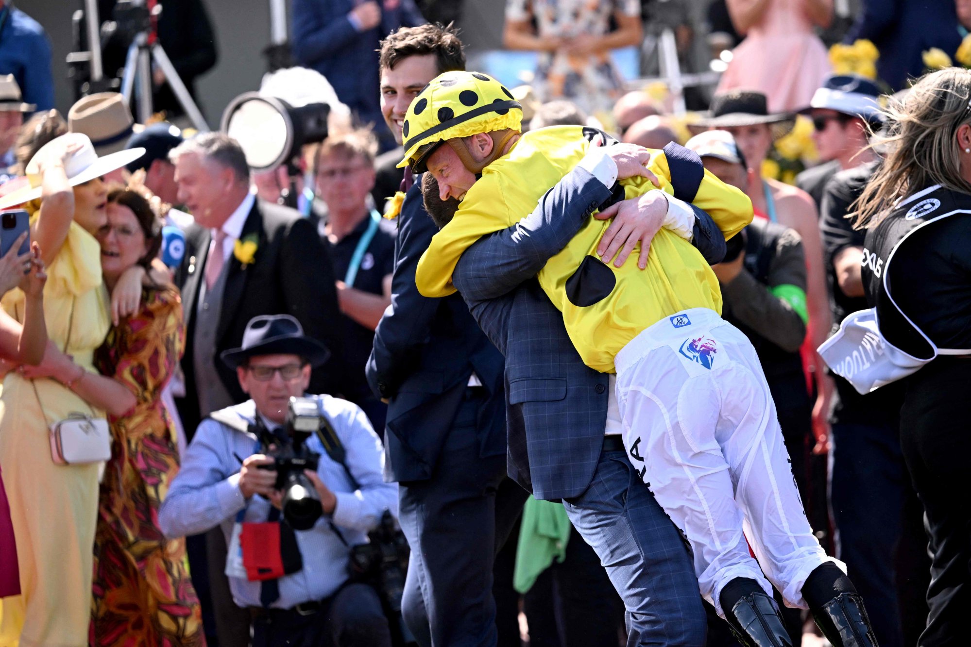 Jockey Mark Zahra is given a hug after winning the Melbourne Cup. Photo: AFP