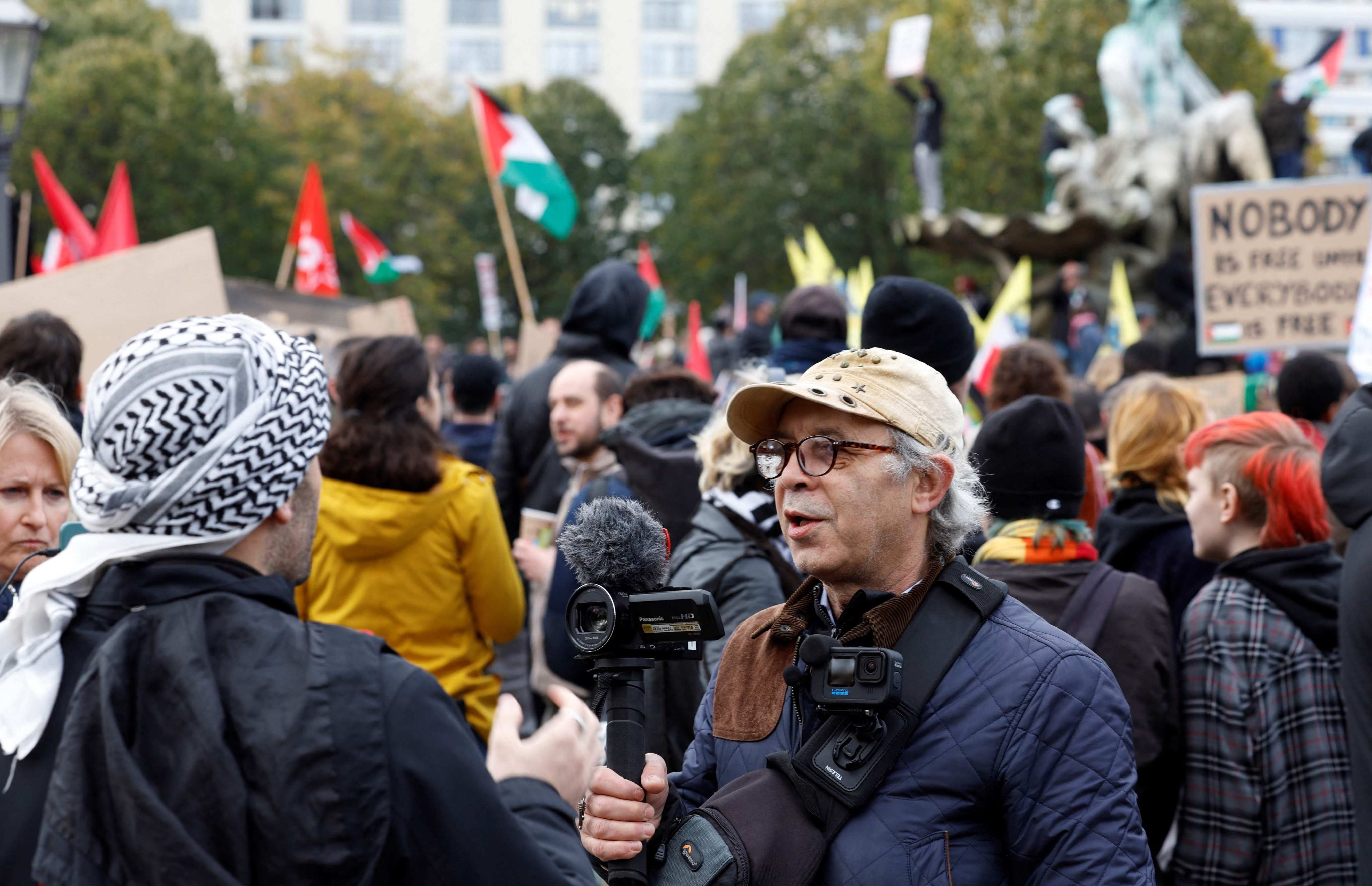 Levi Salomon (R) films during a protest in support of Palestinians under the slogan ‘Free Palestine’ in Berlin, Germany. Photo: AFP