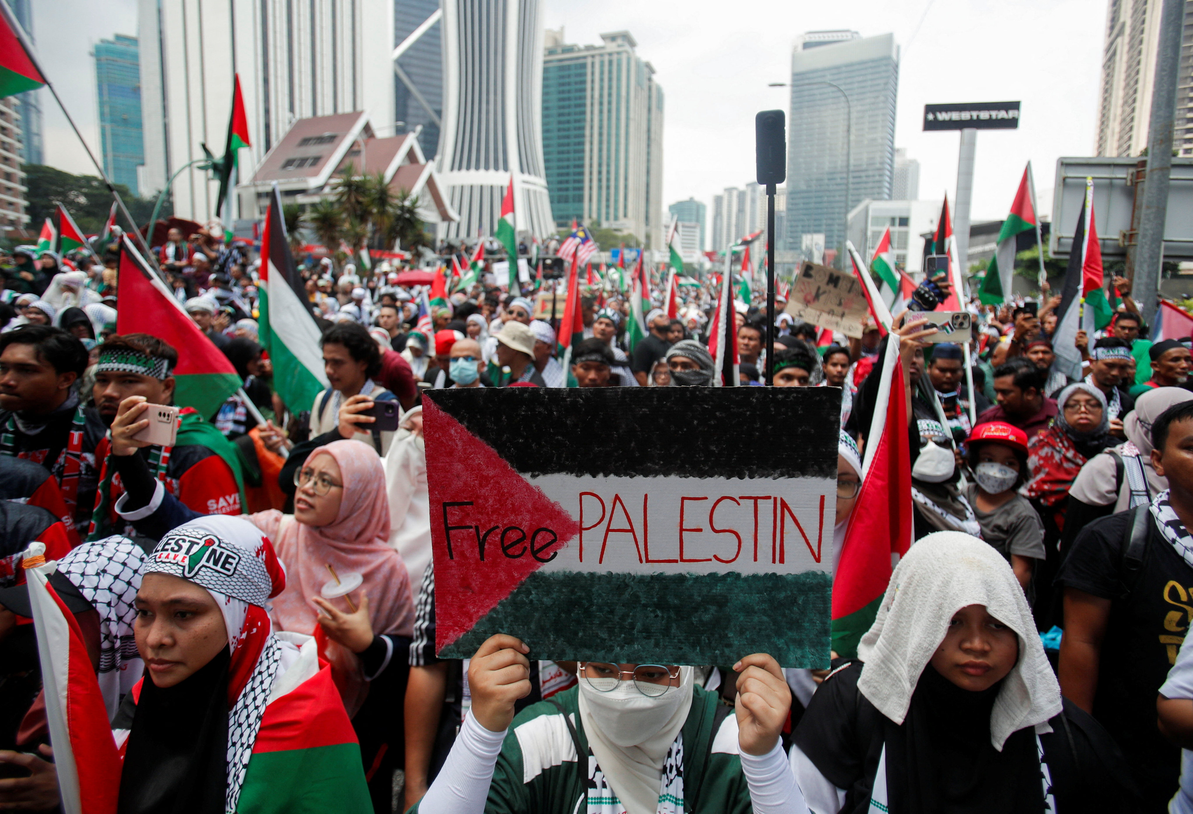 A protester holds a placard painted with the Palestinian flag during a rally outside the US embassy in Kuala Lumpur last month. Photo: Reuters