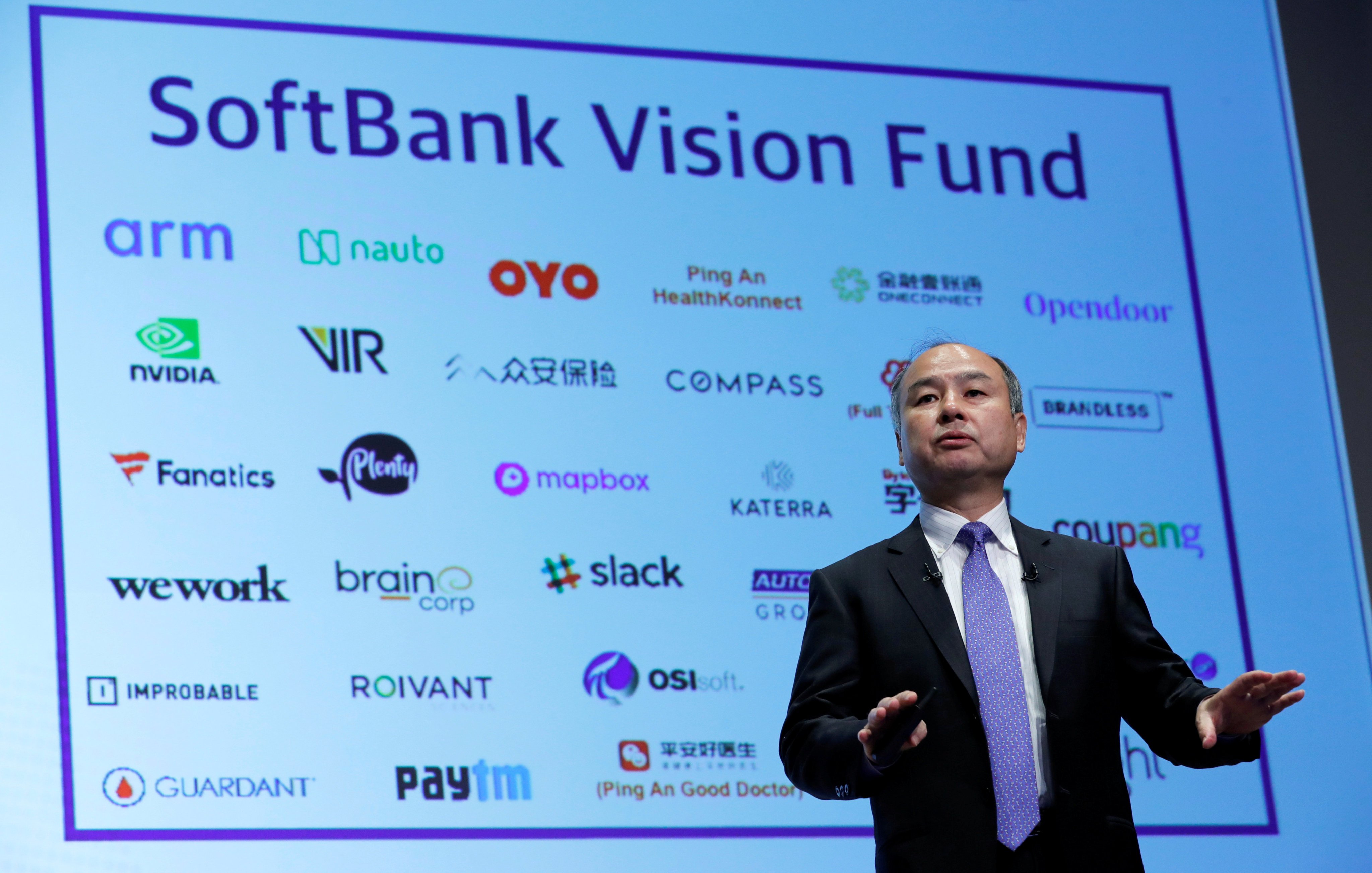 SoftBank Group Corp CEO Masayoshi Son attends a news conference in Tokyo in November 2018, in front of a screen showing the company's portfolio of start-ups. Photo: Reuters