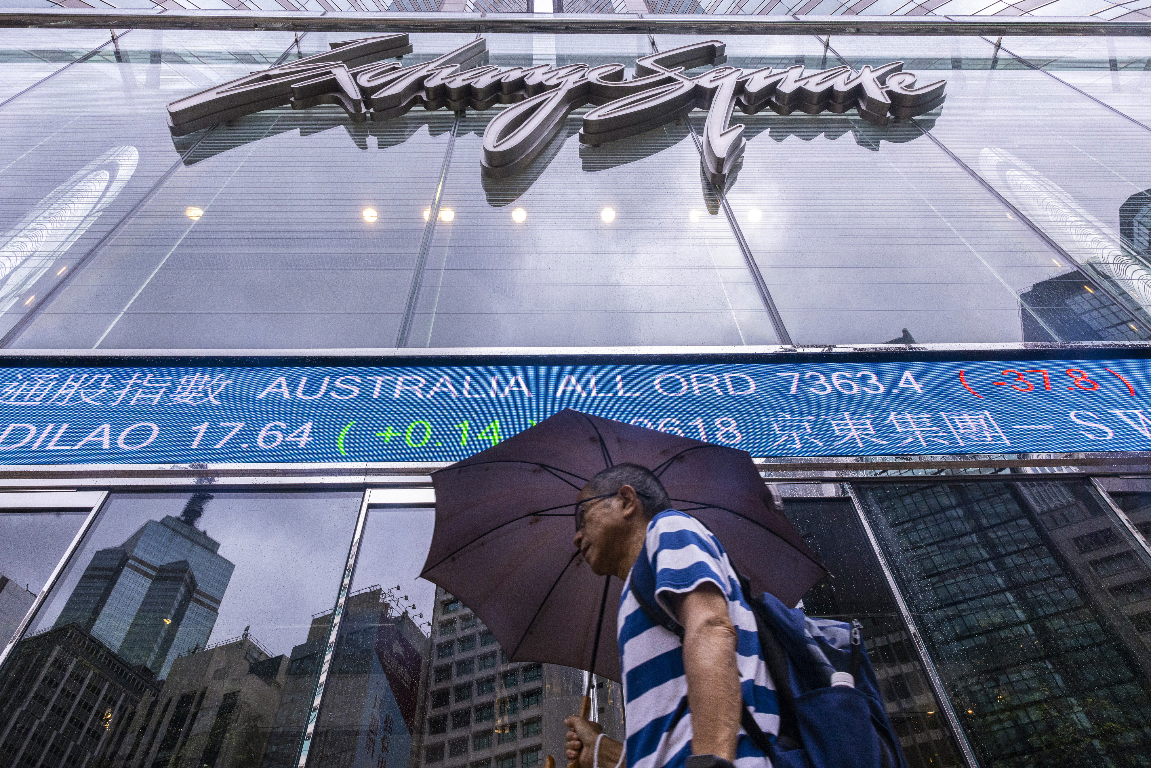 A pedestrian passes by the electronic screen outside the Exchange Square in Central in June 2023. Photo: AP