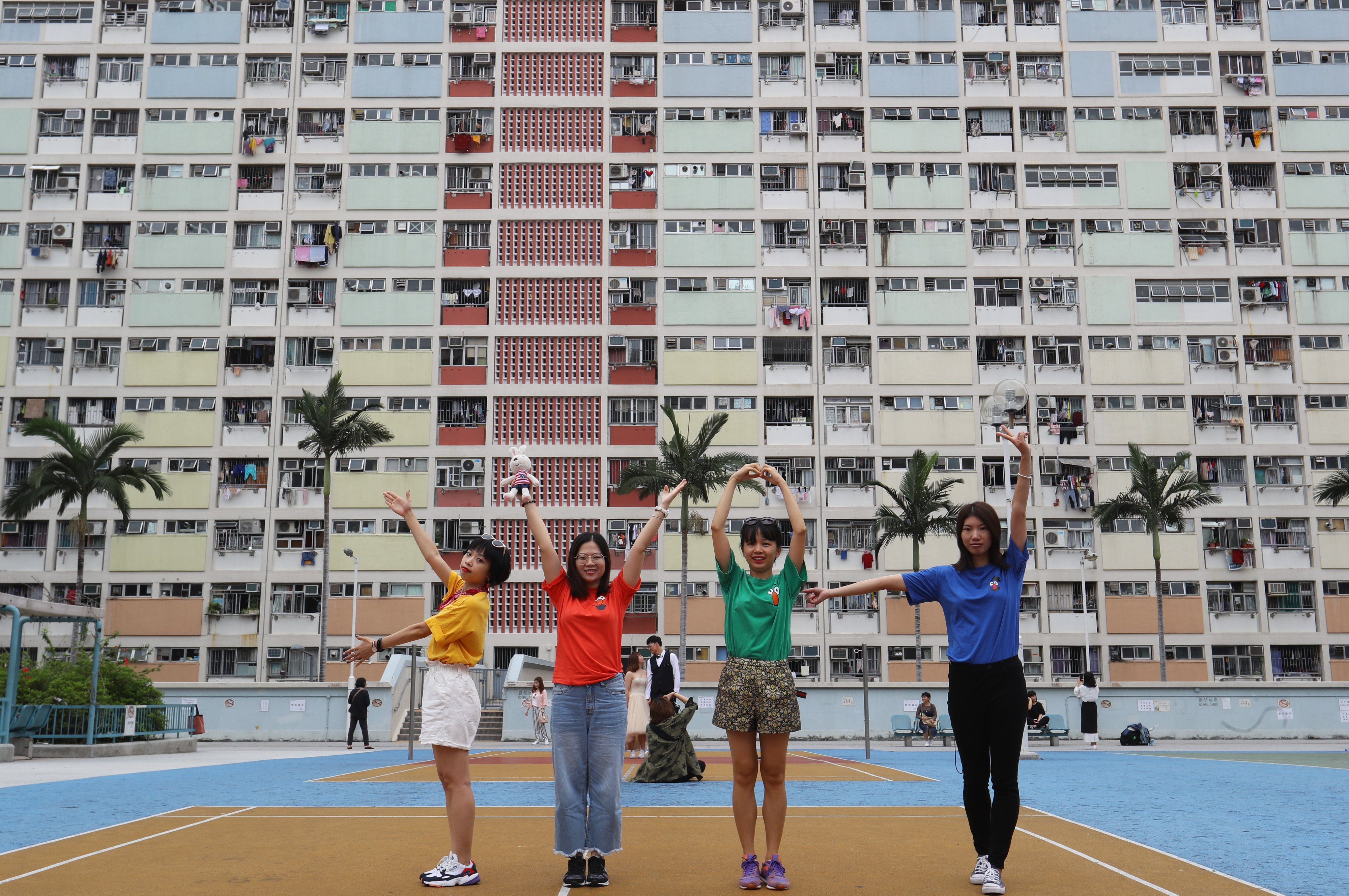 Tourists pose for photos at Choi Hung Estate, whose colourful facade has made it a selfie hotspot, on May 10, 2019. Hong Kong’s per capita living space is only 172 sq ft. Photo: Edmond So