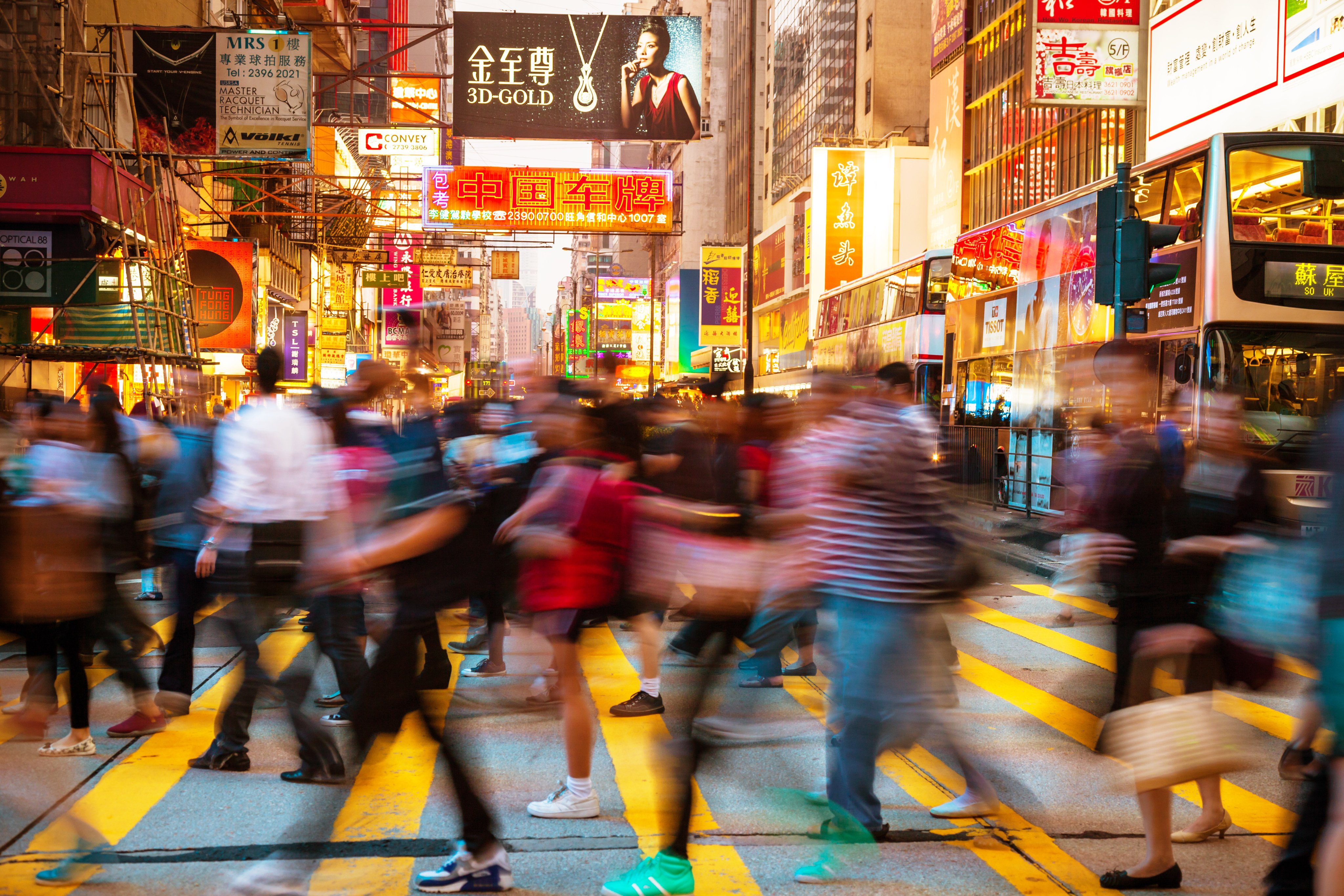 Pedestrians traverse a busy crosswalk in Hong Kong. Photo: Getty Images