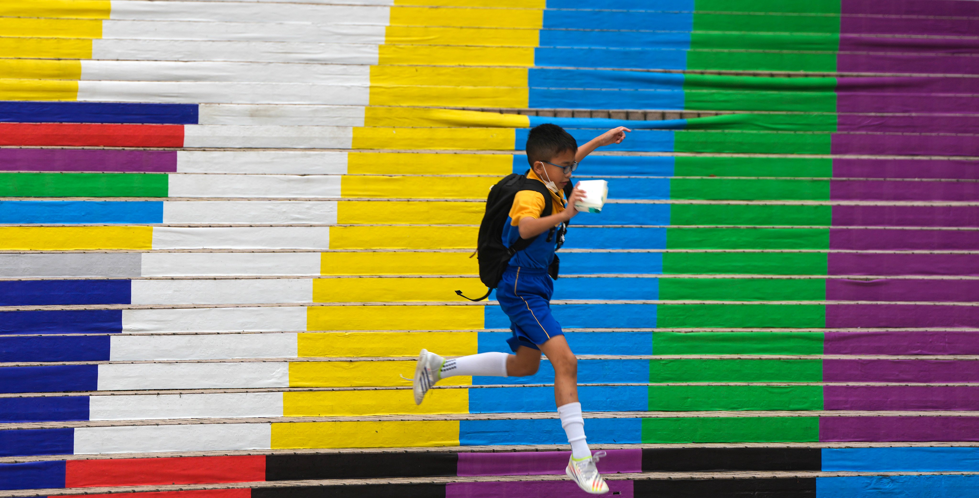 A student jumps on a colourful staircase at the Hong Kong Cultural Centre in Tsim Sha Tsui. The government’s pledge of support for improving students’ mental health is at odds with the grant of just HK$80,000 per school, an amount to be split between the schools and the parent-teacher associations. Photo: Sam Tsang