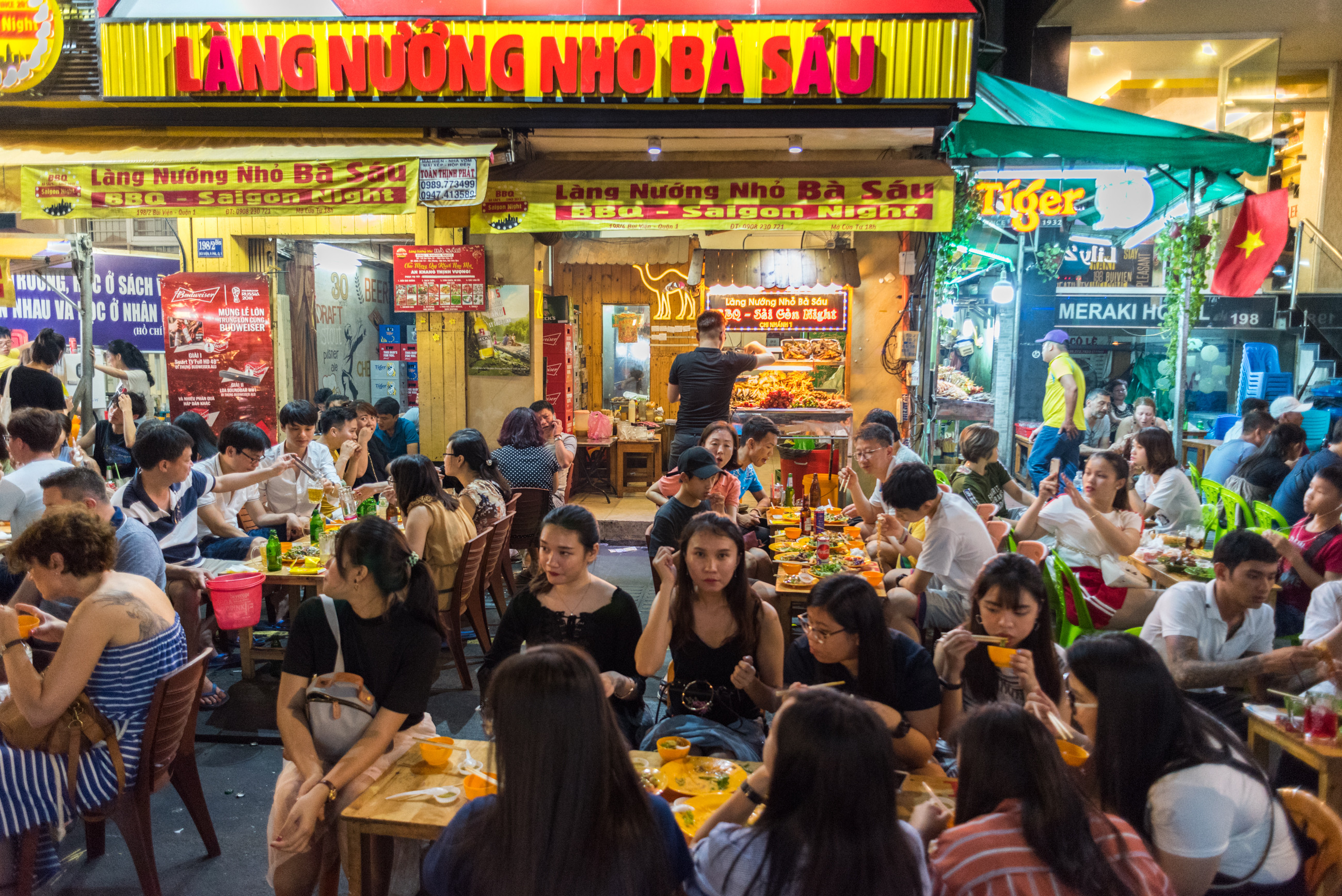Groups of young Vietnamese people enjoy dinner at an open-air restaurant in Ho Chi Minh City. Vietnamese youth are starting to question the purpose of work in an economy where spoils are increasingly out of reach of the young. Photo: Shutterstock