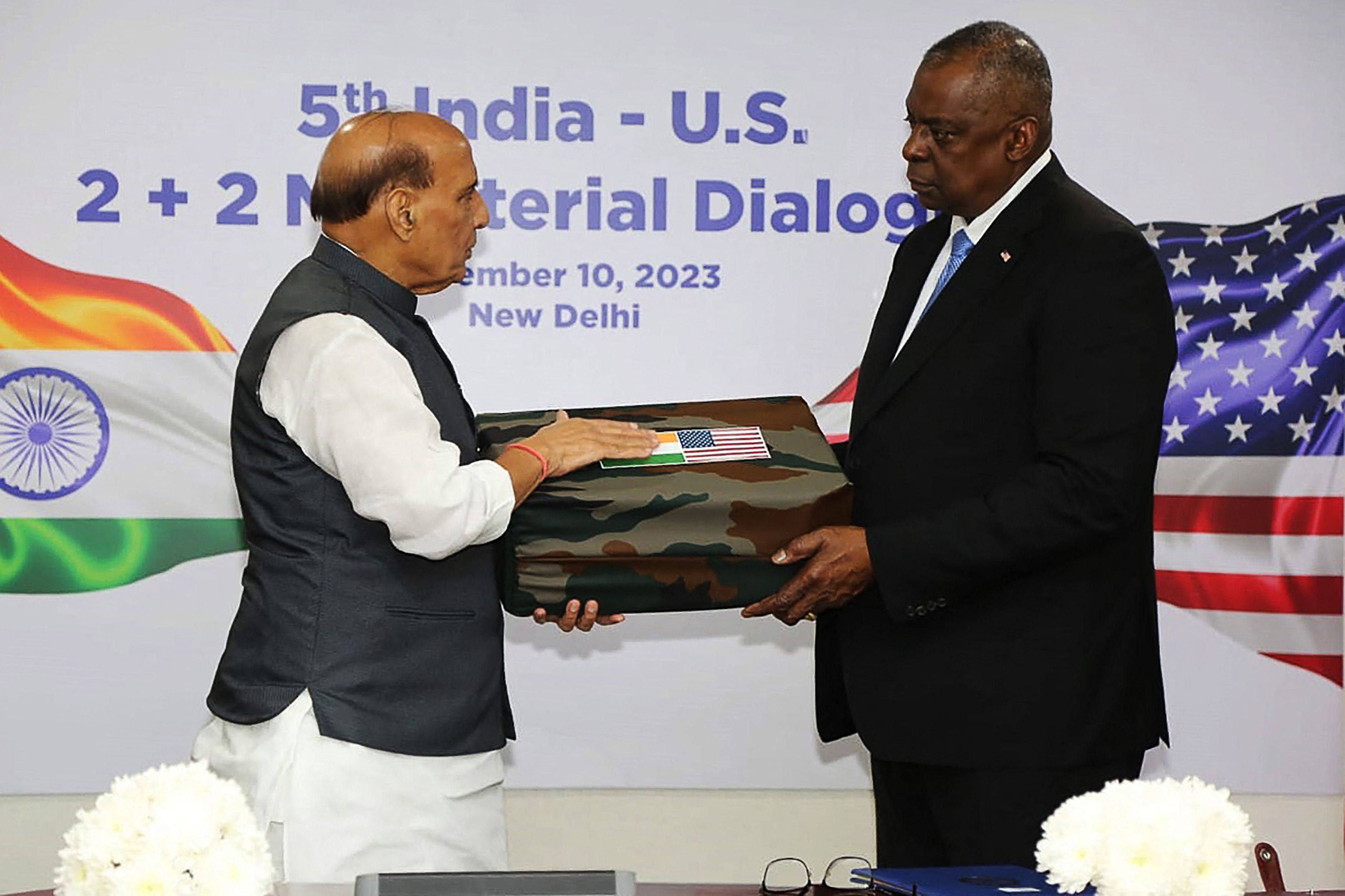Indian Defence Minister Rajnath Singh presents parts of a recovered US Army parachute, uniform and airplane from World War II to US Defence Secretary Lloyd Austin on Friday in New Delhi. Photo: AFP/Indian Press Information Bureau