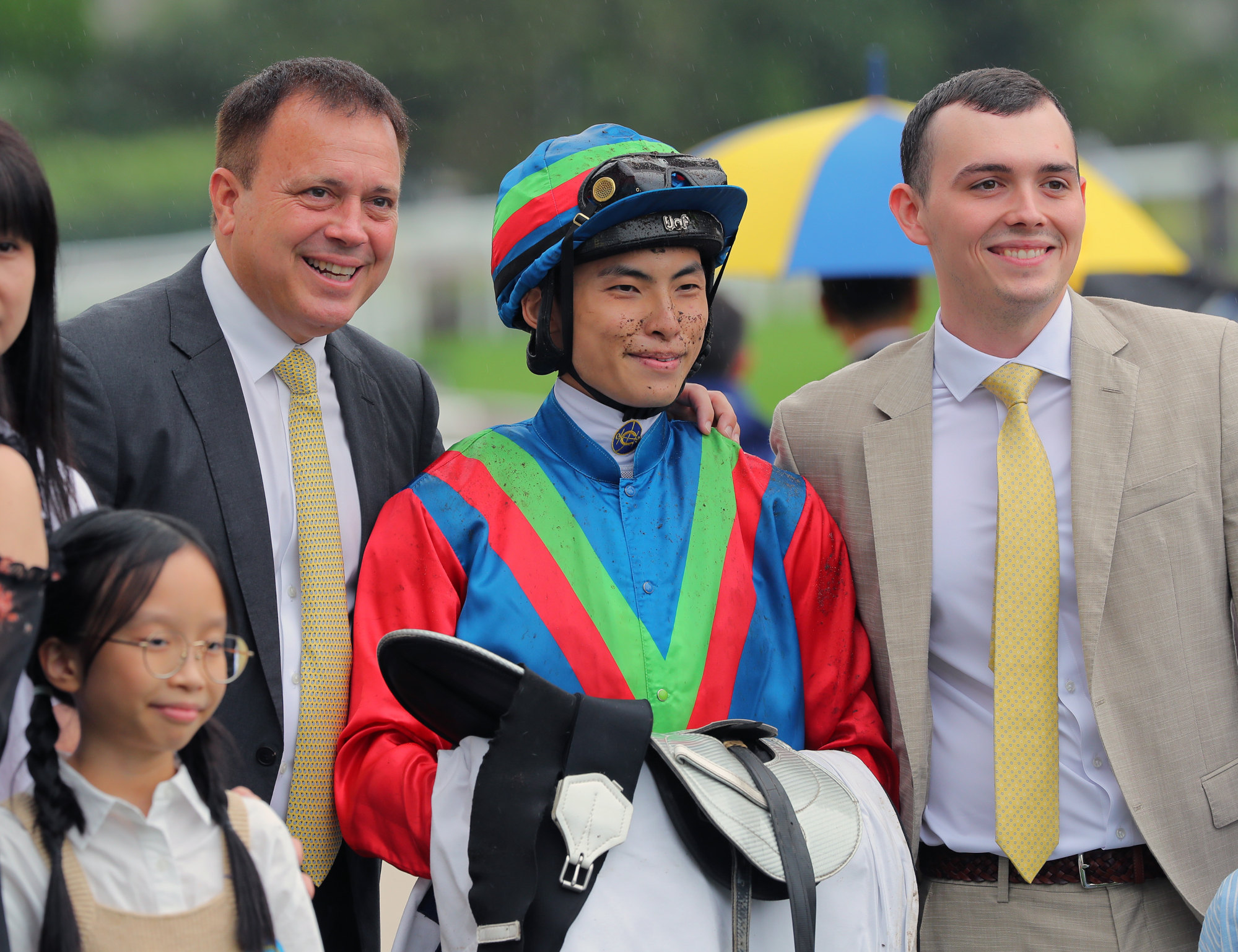 Jockey Ellis Wong celebrates Kaholo Angel’s win with Caspar (left) and Ronan Fownes.