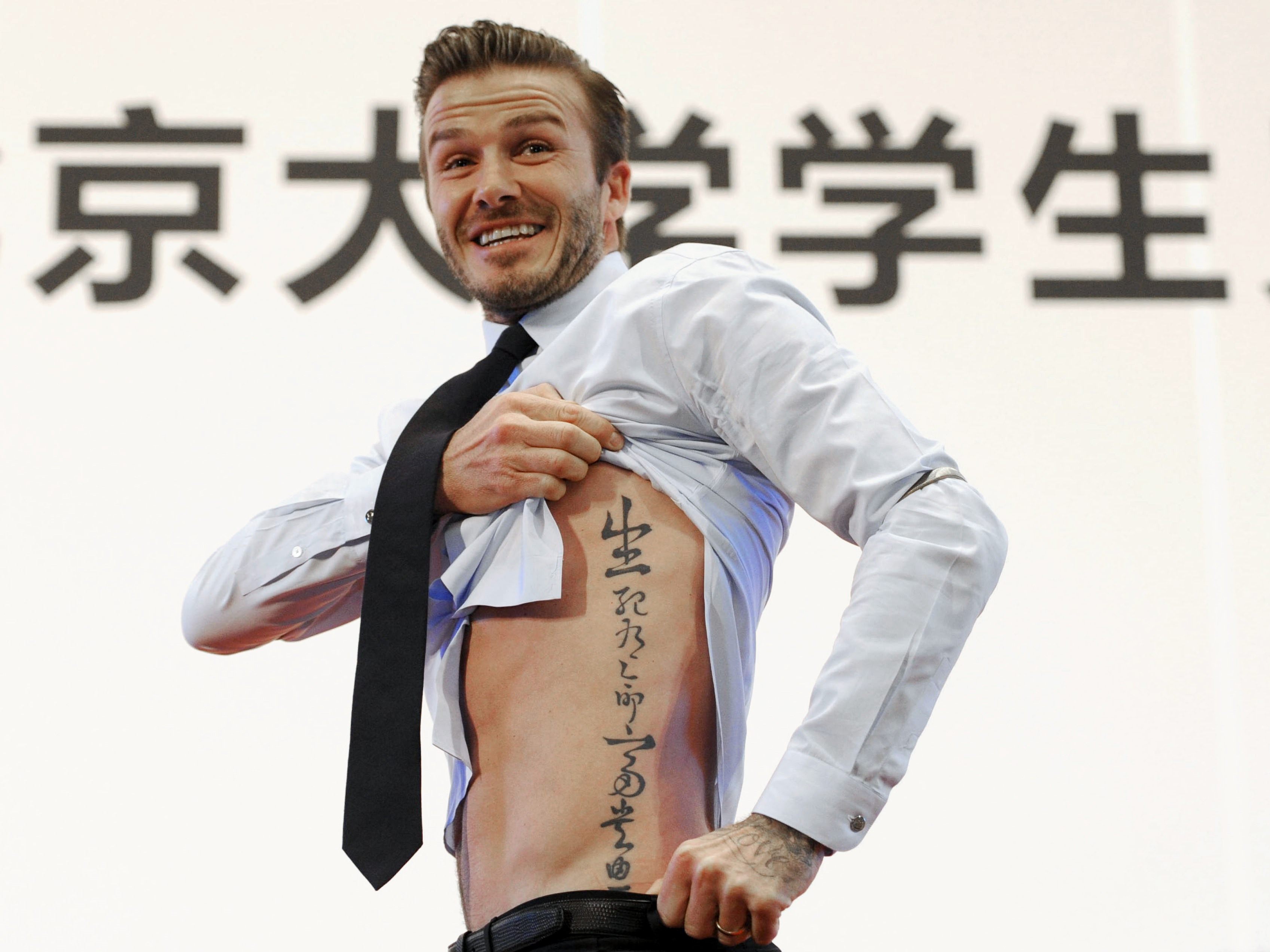 David Beckham is just one of many celebrities who rocks tattoos, but who does he get inked by? Photo: Reuters