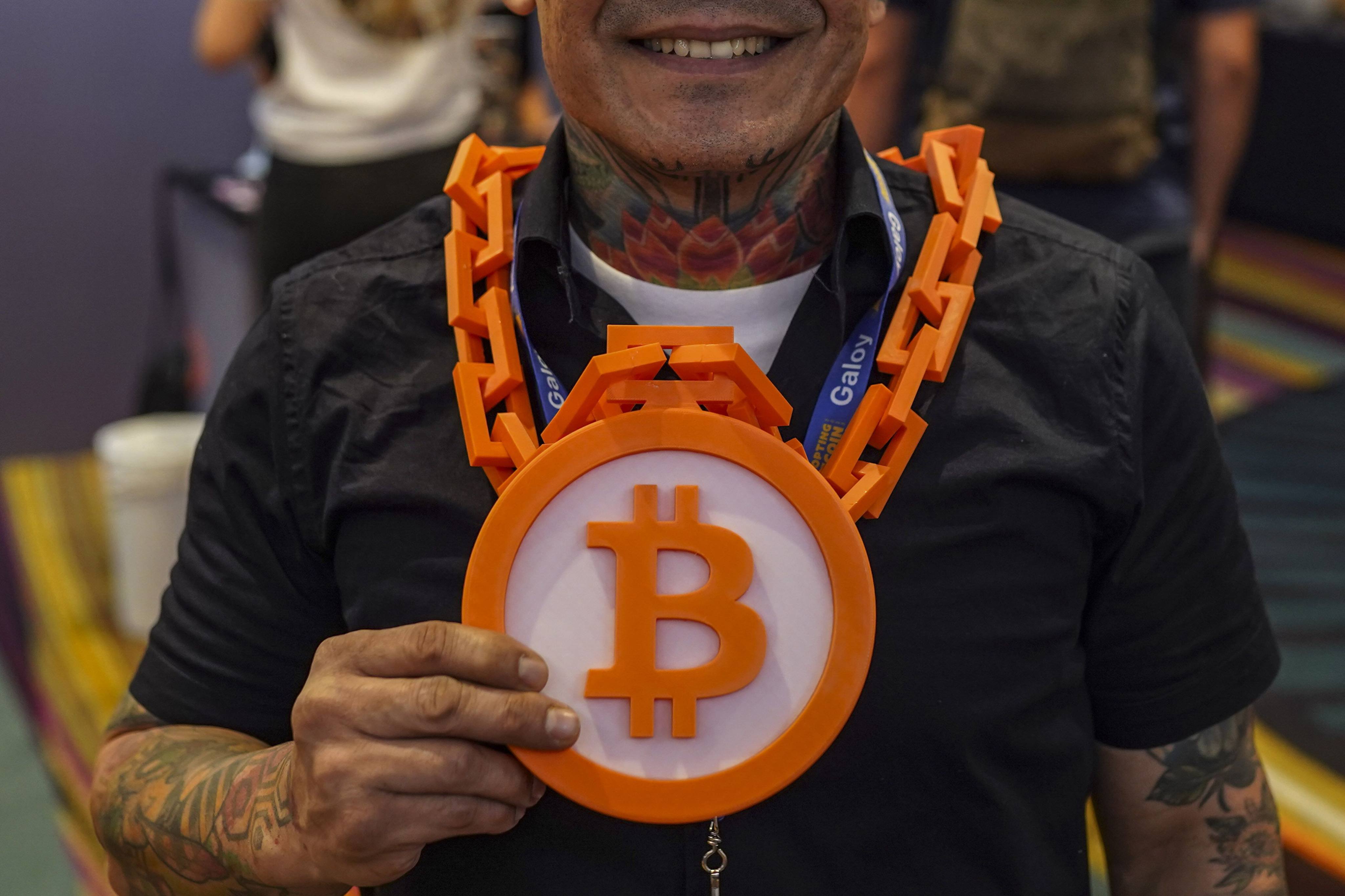 An attendee wearing a necklace featuring the Bitcoin logo during the Adopting Bitcoin summit in San Salvador, El Salvador, on November 7. The United States has a reputation for being the home of innovation, but the lack of clarify on cryptocurrency regulation has opened the door for other countries to emerge as hubs for the industry. Photo: Bloomberg