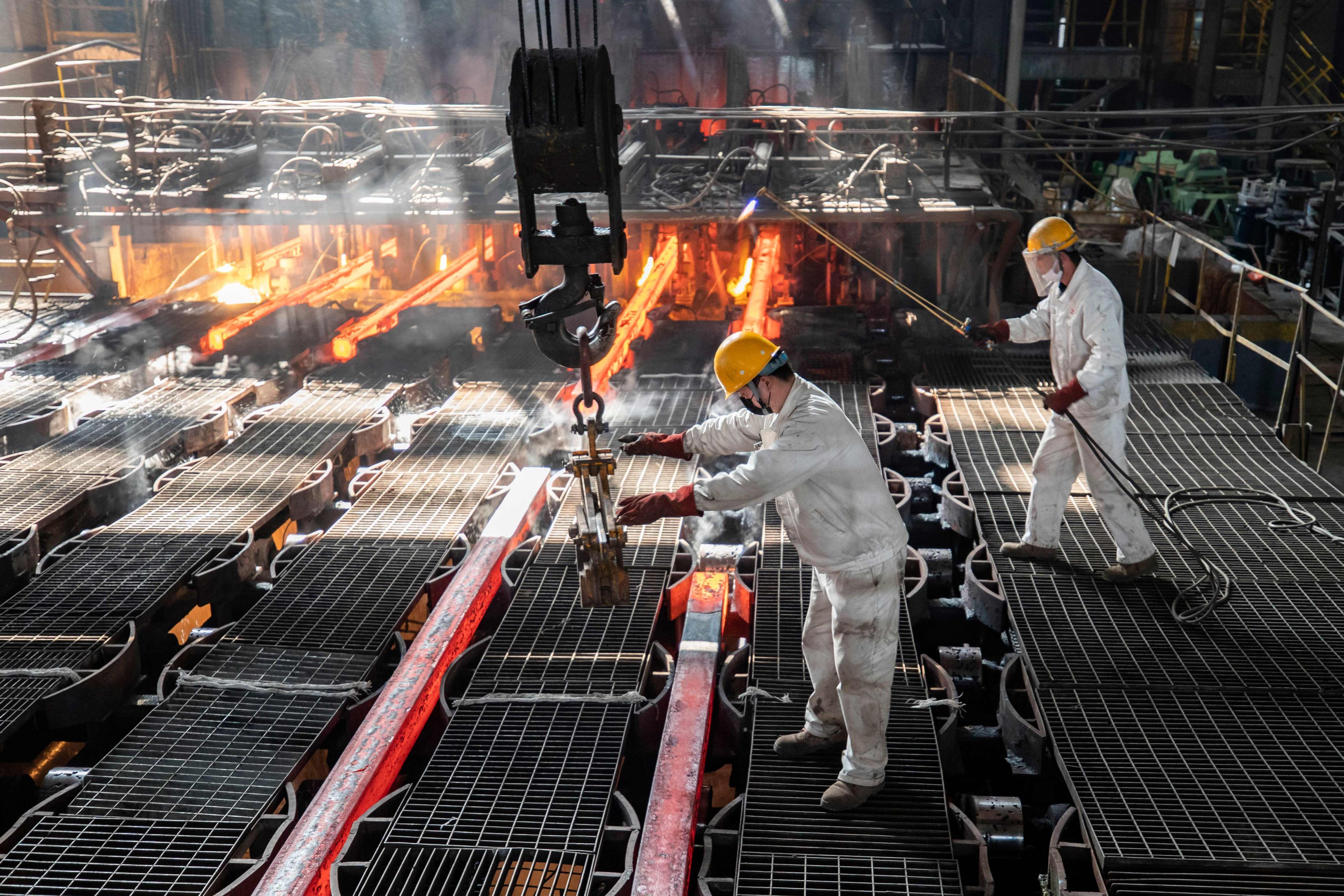 Workers make iron bars in a steel factory in Lianyungang, in Jiangsu province, on February 12, 2021. China’s exposure to the Carbon Border Adjustment Mechanism is mostly concentrated in the steel sector, which represents less than 2 per cent of the value of Chinese exports to the EU. Photo: AFP