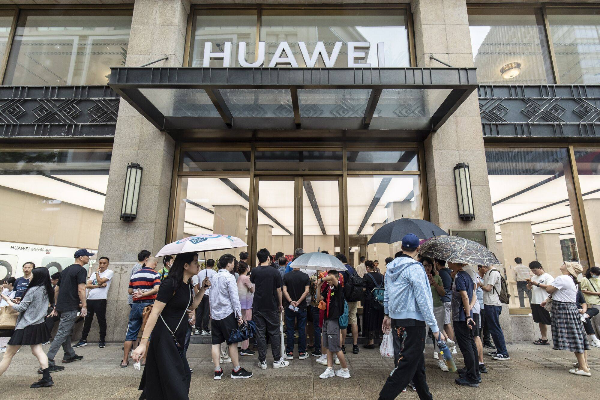 Customers wait outside a Huawei flagship store in Shanghai before it opens in the morning. Photo: Bloomberg