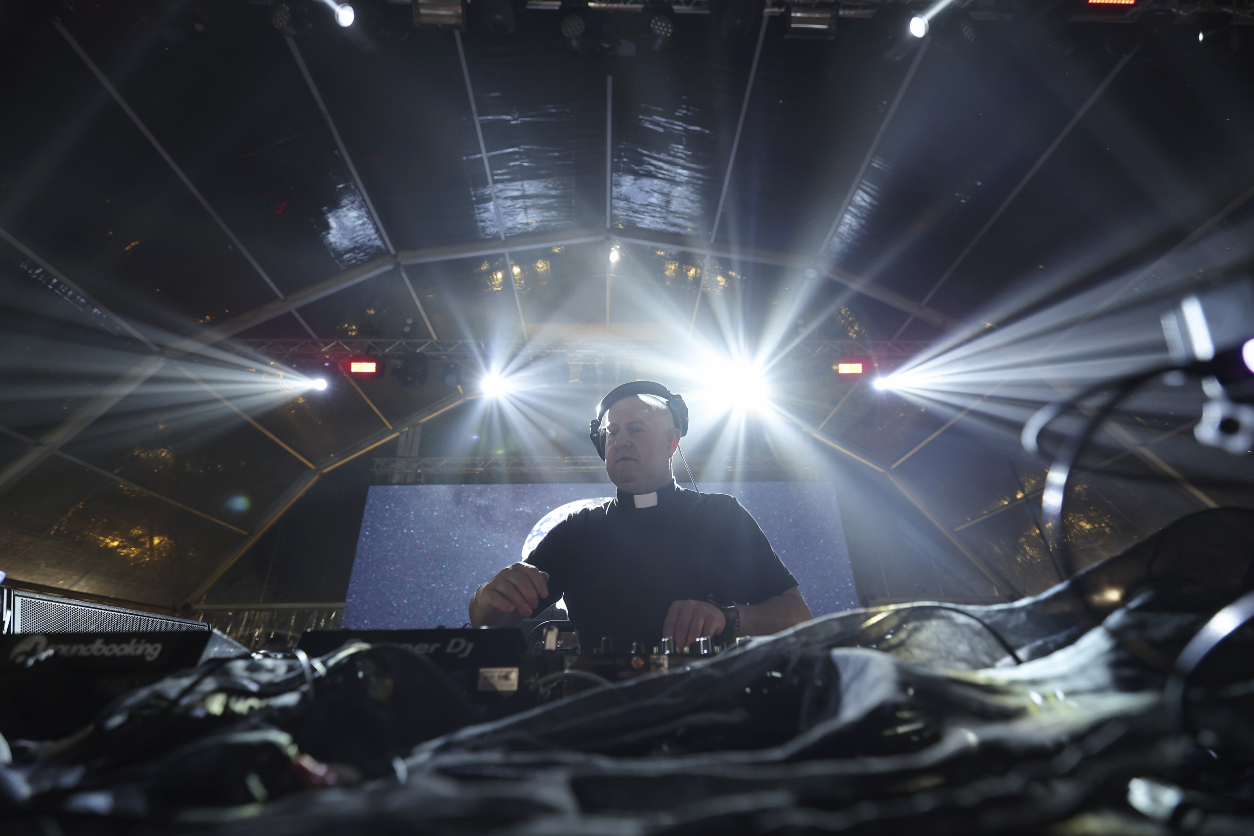 Roman Catholic priest Guilherme Peixoto plays a DJ set together with the Portuguese Army Symphonic Band during Army Day celebrations in Viana do Castelo, Portugal, on October 26, 2023. Peixoto hopes his music can help bring more young people into the church. Photo: AP