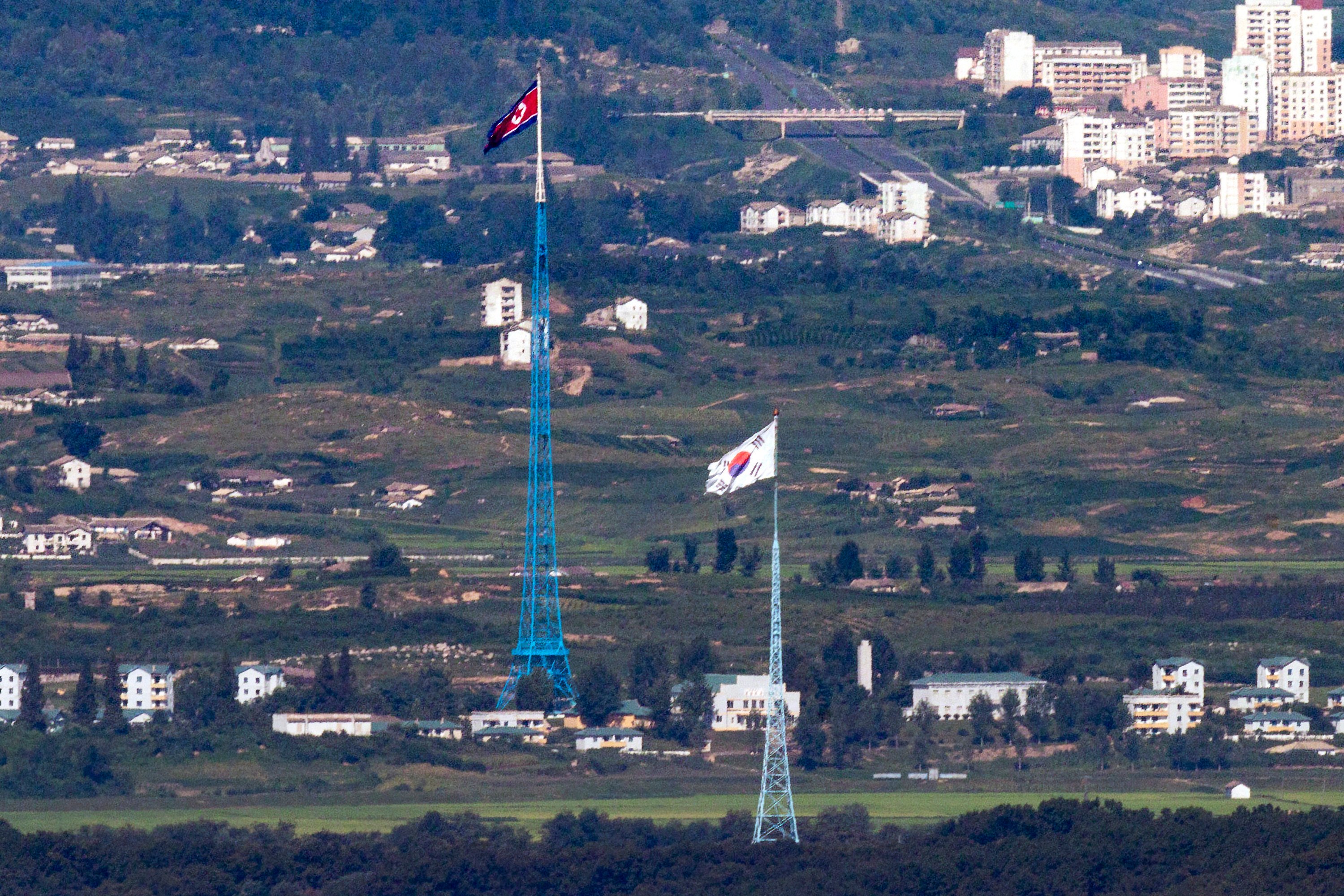 Flags of North Korea (rear) and South Korea from the border area between the two Koreas in Paju, South Korea. South Korea plans to launch its first home-grown spy satellite at the end of November. File photo: AP