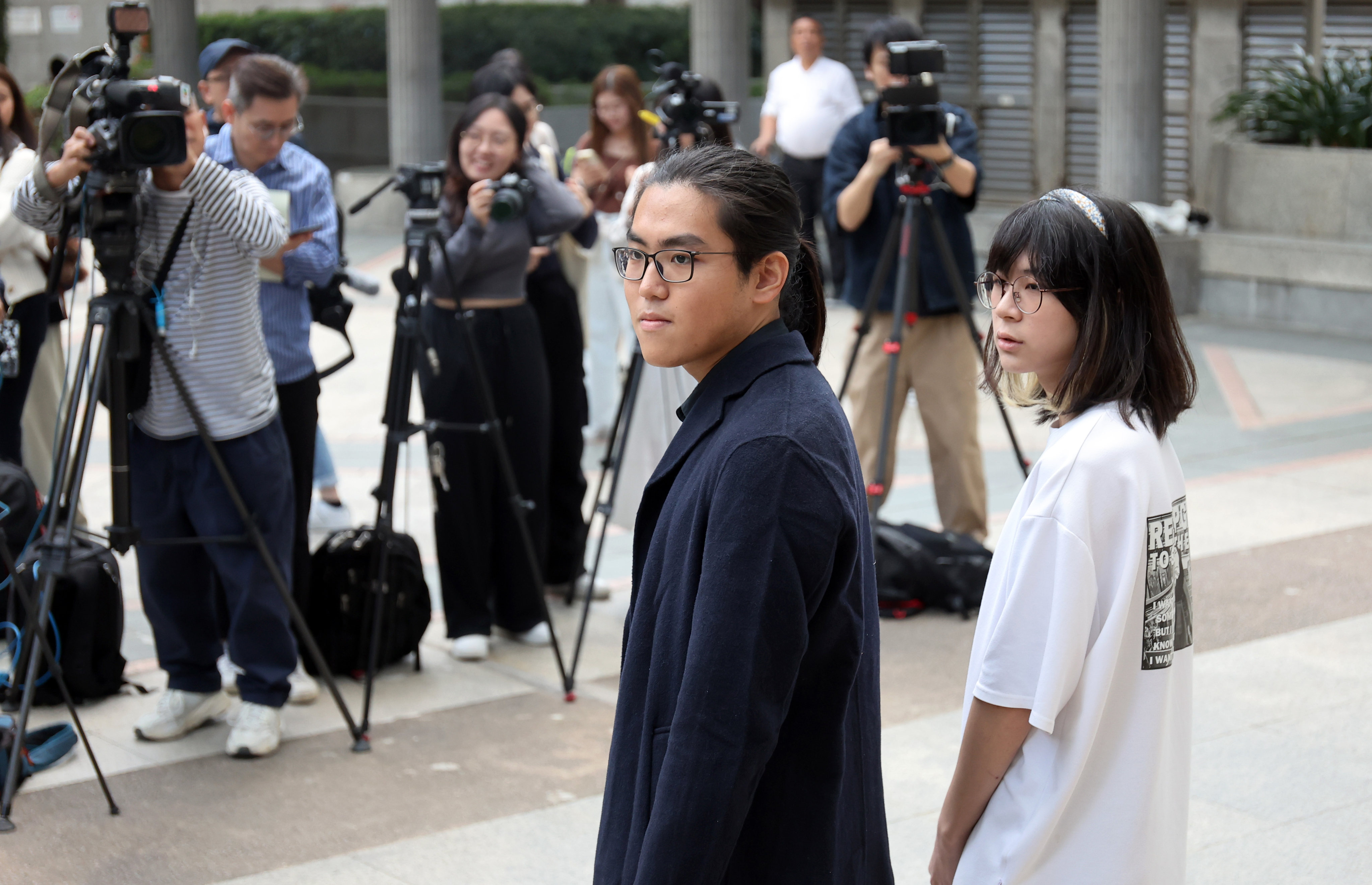 Ecarret Wong and Nathan Lam meet the media after filing their hair discrimination claims in Wan Chai. Photo: Edmond So
