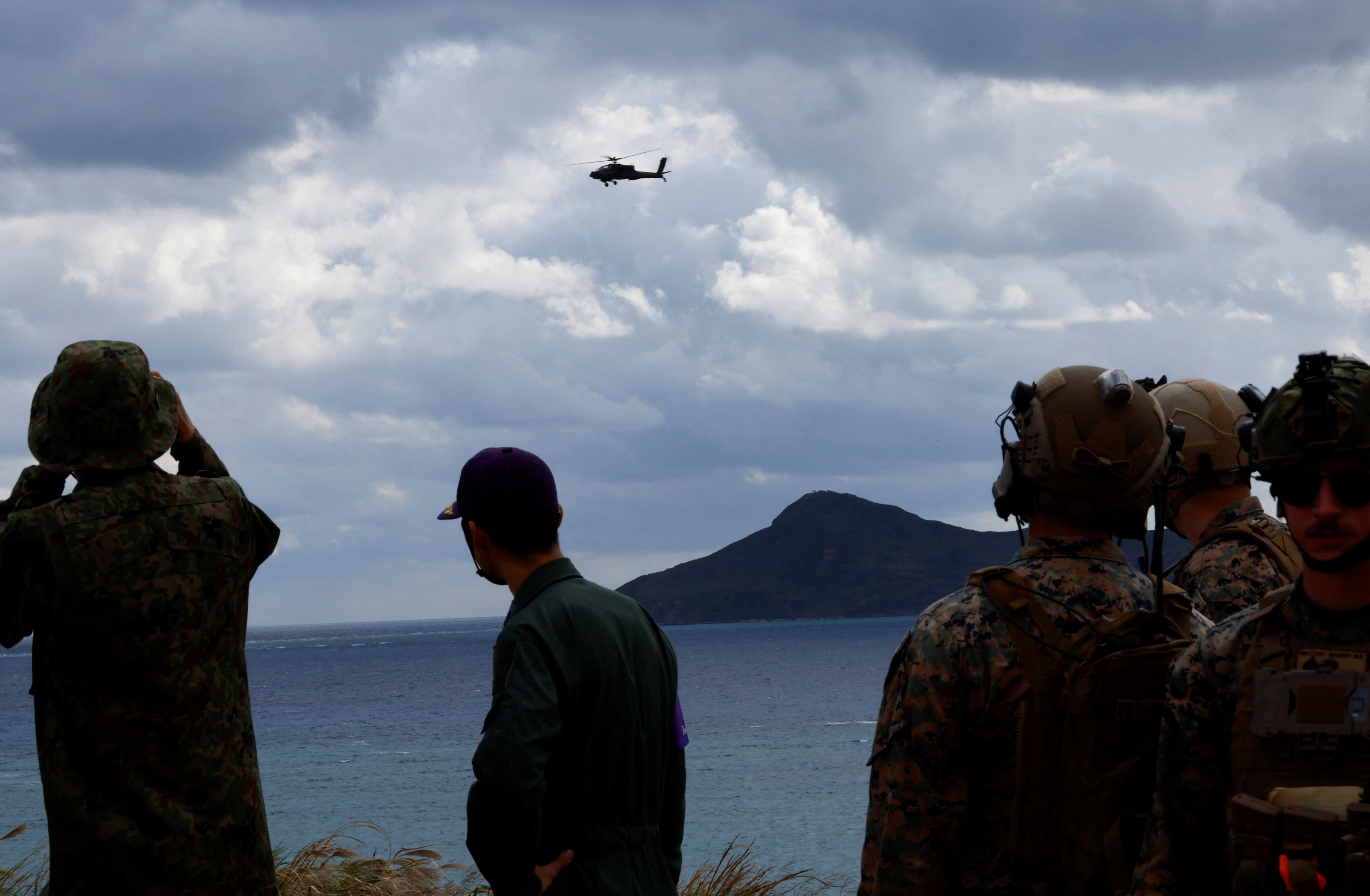 Japanese Ground Self-Defence Force’s Apache helicopter flies over its Amphibious Rapid Deployment Brigade soldiers and the US Marines during the brigade’s military drill at an uninhabited Irisuna island close to Okinawa. Photo: Reuters