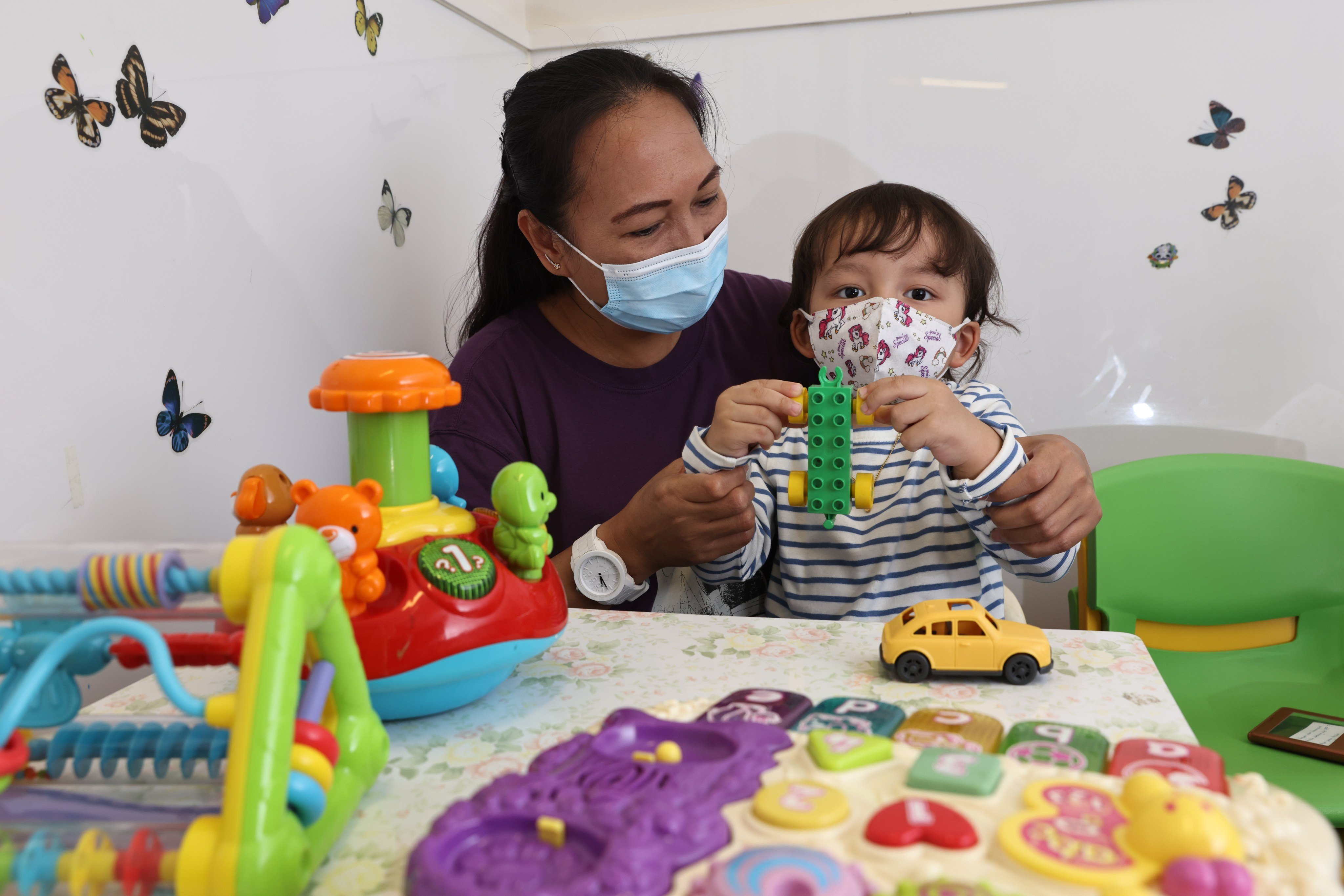 A migrant worker mother and her child in October 2021. In Hong Kong, children born to foreign domestic workers may not have access to public healthcare and welfare services. Photo: K. Y. Cheng