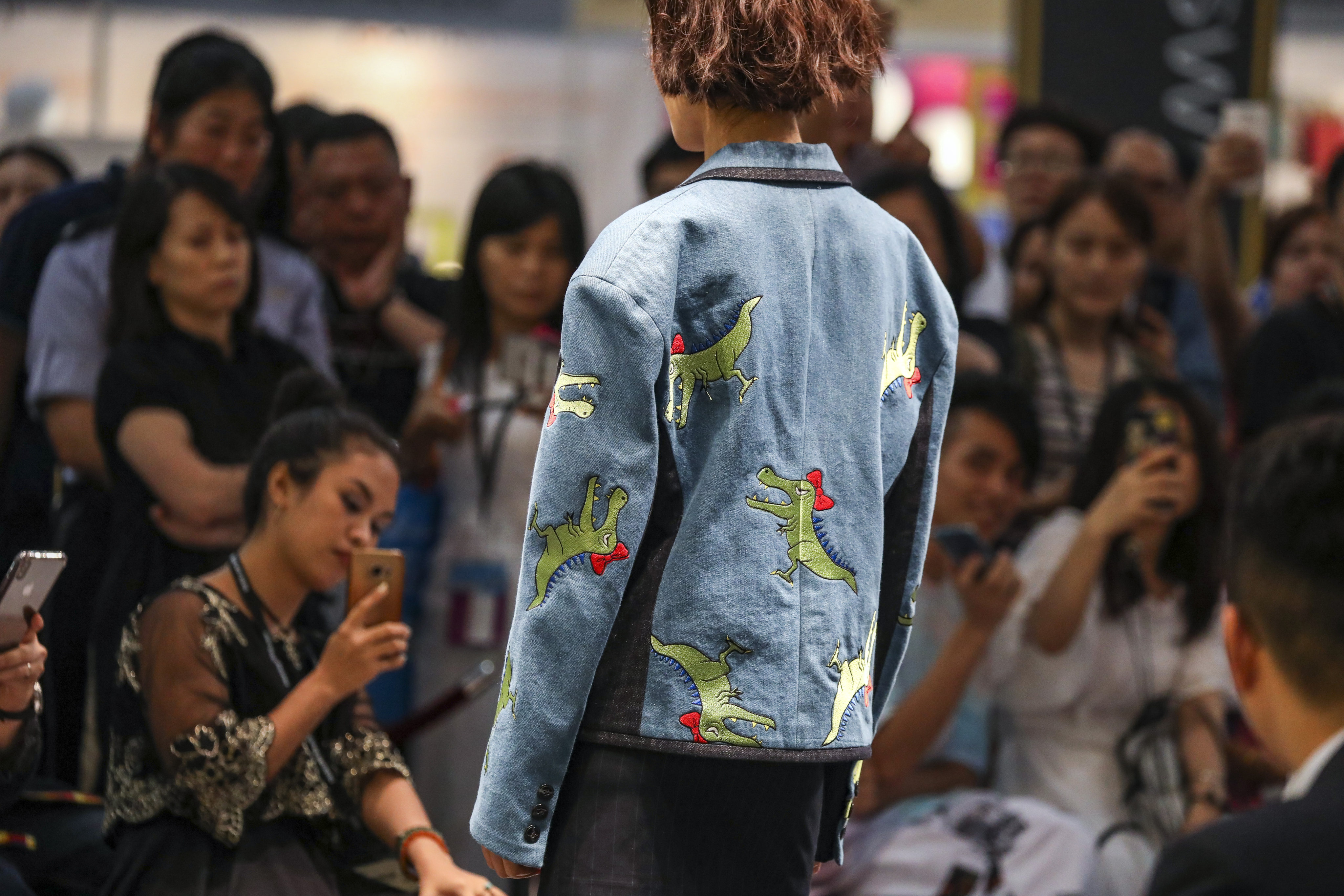 People take photos of a show at the Hong Kong Fashion Week  in July 2019. Hong Kong’s design and manufacturing ecosystem and its links to the Greater Bay Area and the rest of Asia are advantages it should tap. Photo: Nora Tam