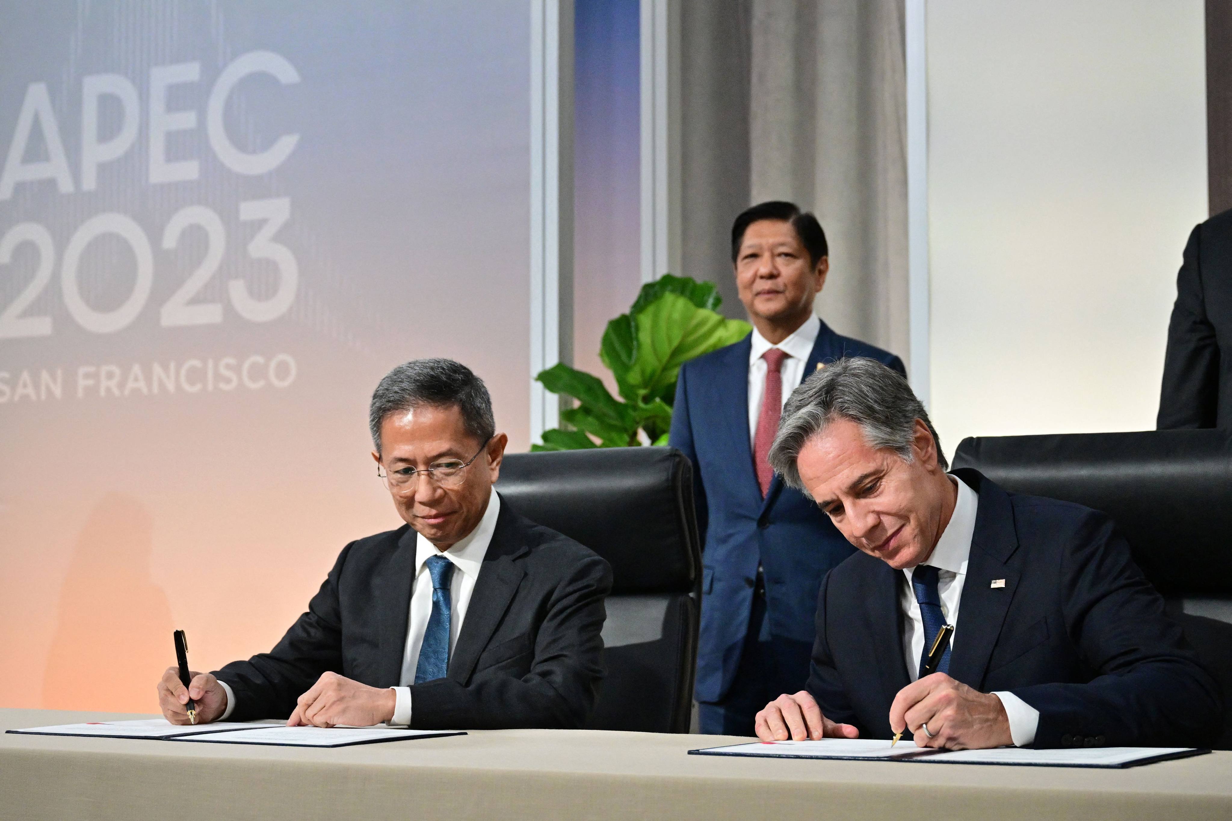 US Secretary of State Antony Blinken (right) and Philippine Secretary of Energy Raphael Lotilla sign the 123 Agreement in the presence of President Ferdinand Marcos Jnr (centre) in San Francisco on November 16. Photo: AFP
