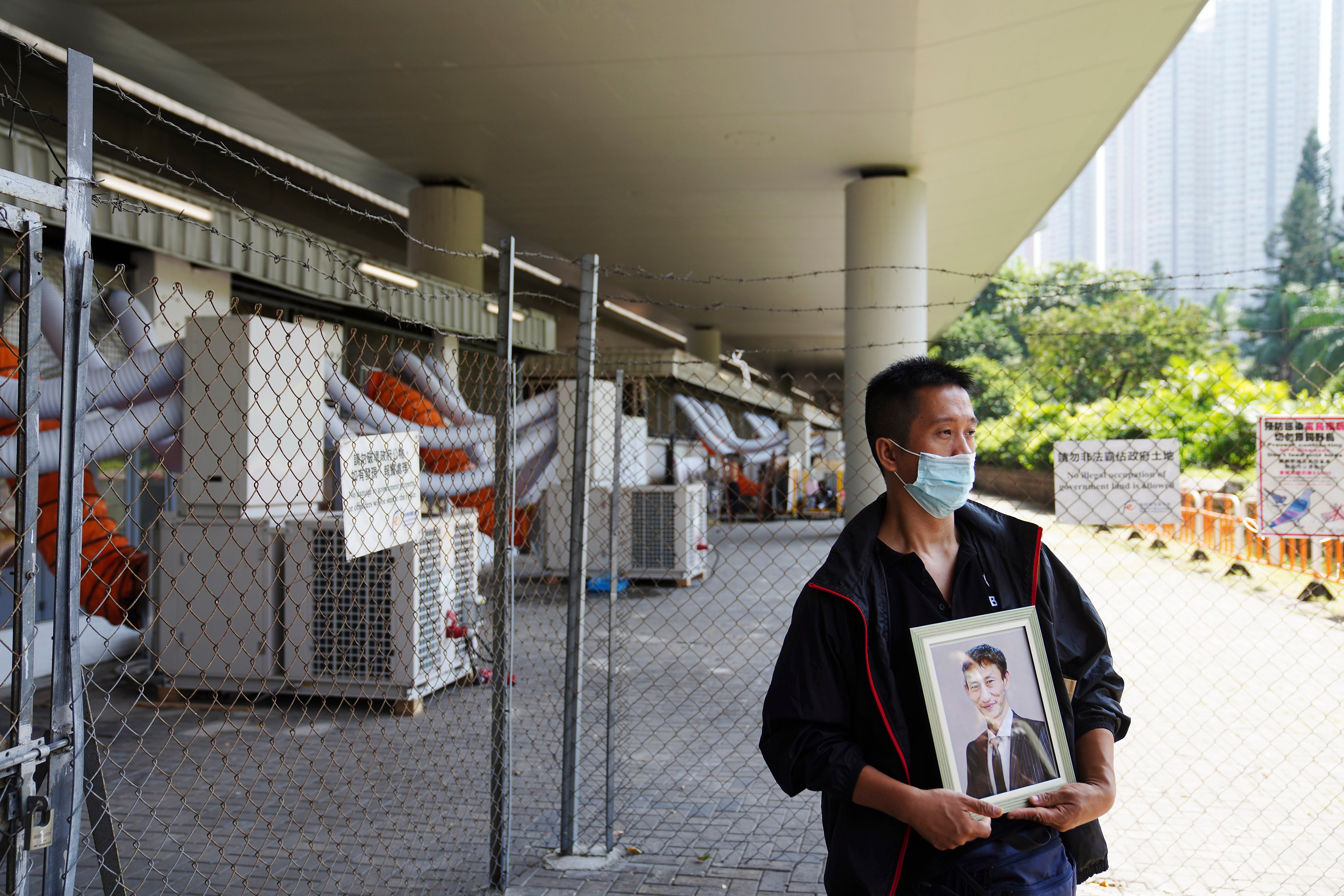 A volunteer holds a picture of Le Van Muoi, a 54-year-old who died at a psychiatric institution. Photo: Sam Tsang
