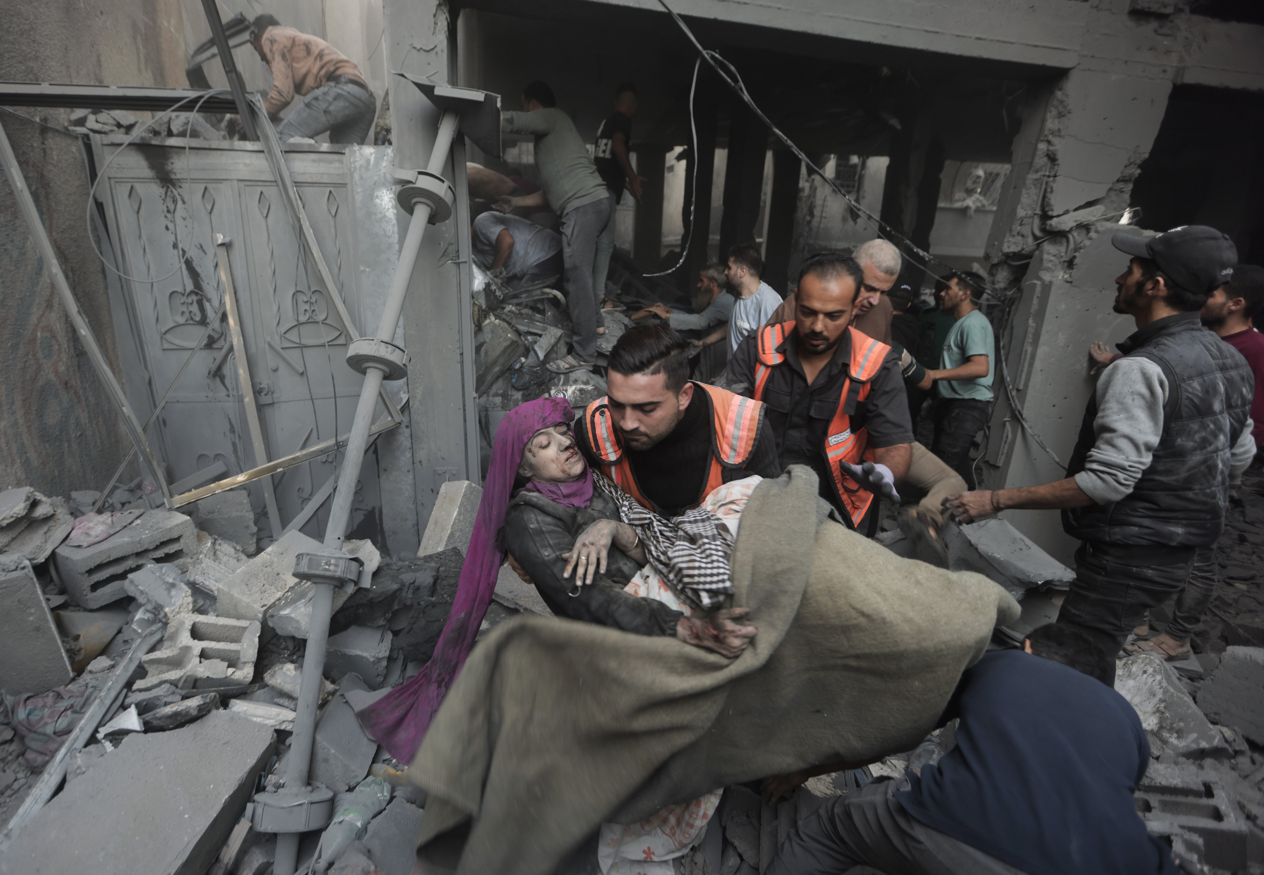 Palestinian rescuers evacuate an injured woman  found under the rubble of a destroyed house following an Israeli airstrike in Khan Younis refugee camp. Photo: AP
