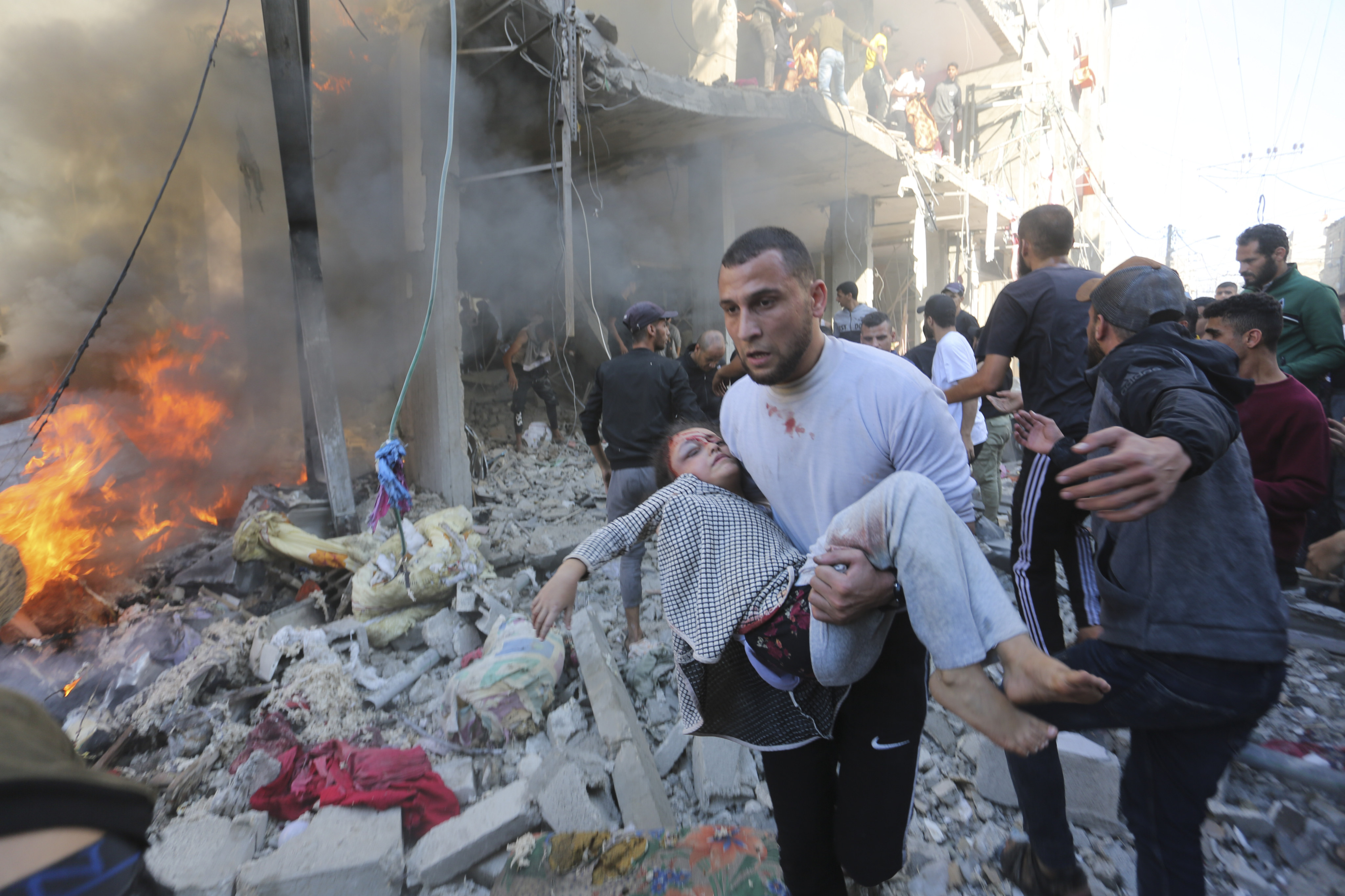 Palestinians rescue survivors after an Israeli strike on Rafah, in the Gaza Strip on Friday. Photo: AP