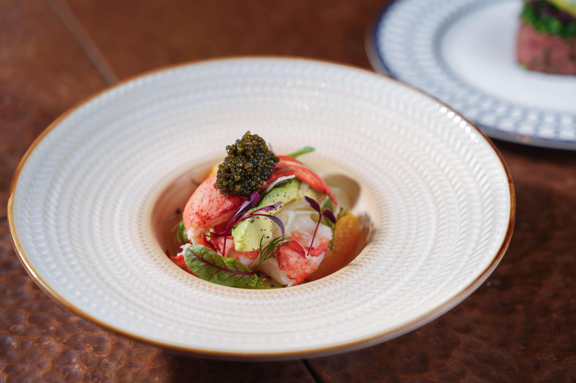 Grand Hyatt Steakhouse’s Boston lobster salad is served with a zingy orange dressing, fennel, orange segments, avocado and a scoop of Oscietra caviar. Photo: Grand Hyatt Steakhouse