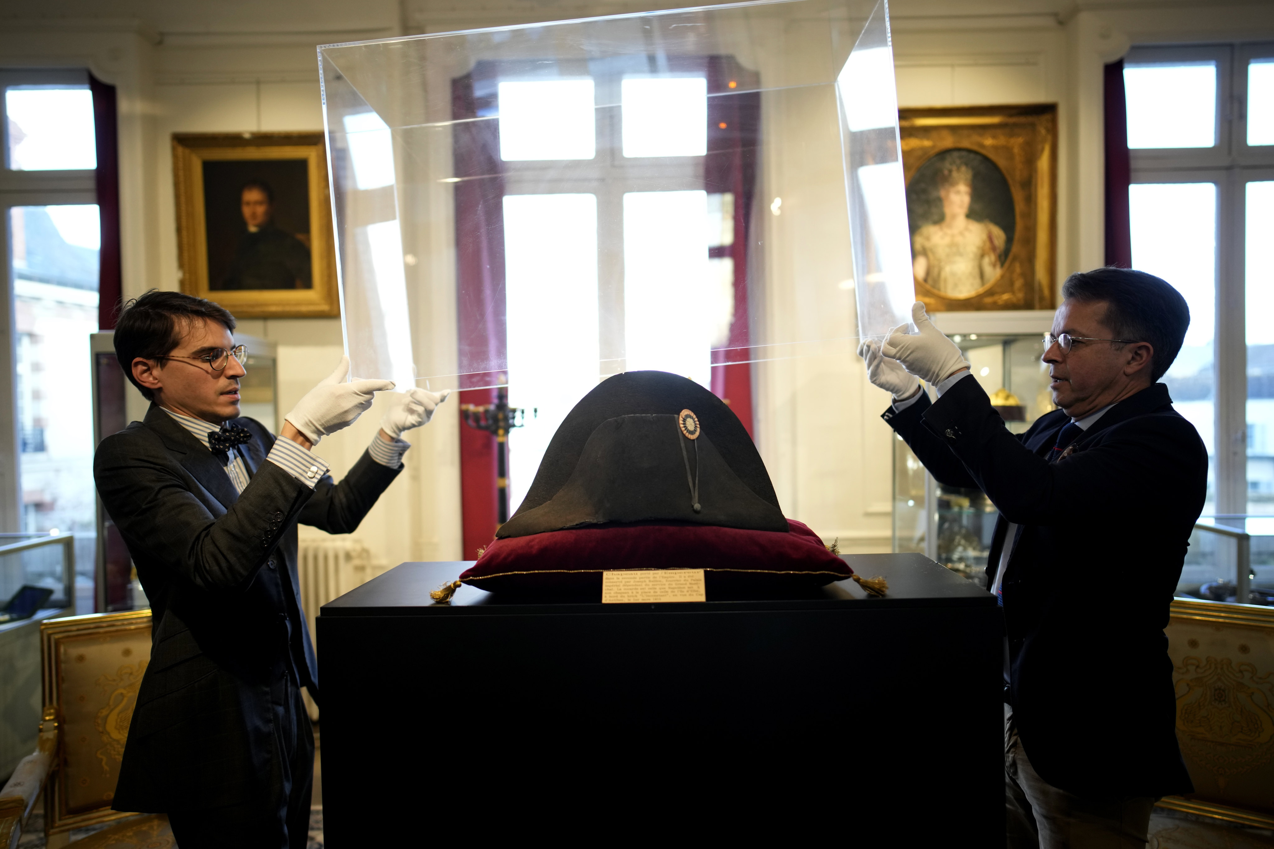 Staff at Osenat’s auction house in Fontainebleau, south of Paris, remove the protective case of one of the signature broad, black hats that Napoleon Bonaparte wore when he ruled 19th-century France and waged war in Europe. Photo: AP