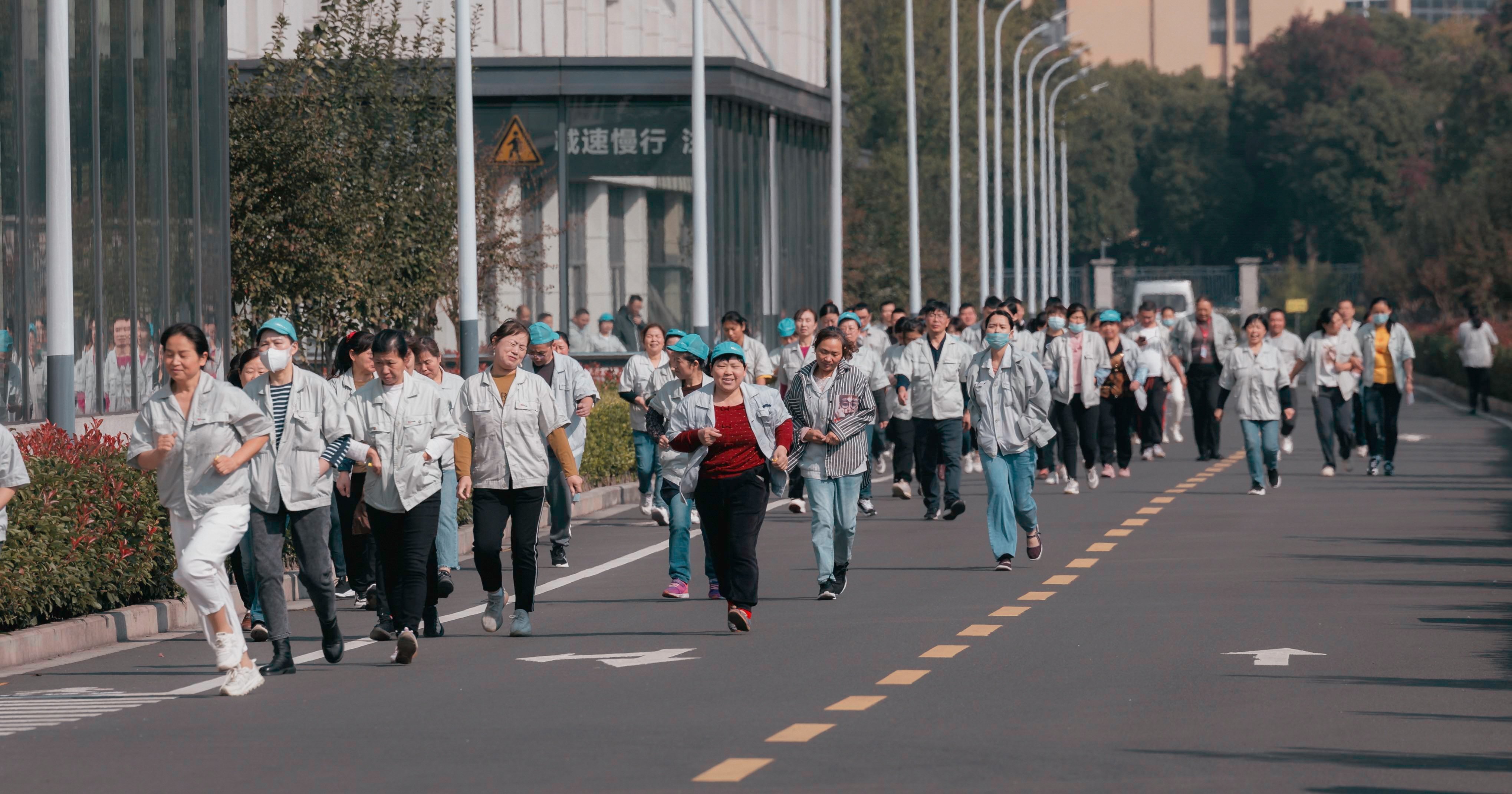 Some workers run to have lunch at the Hualida clothing factory canteen in Changzhou, Jiangsu province, on November 14. 
Retirement age in China is among the lowest globally – 60 for men, 55 for white-collar women. But with better nutrition and healthcare, workers in this cohort are retiring with longer, healthier lives ahead of them. Photo: EPA-EFE 
