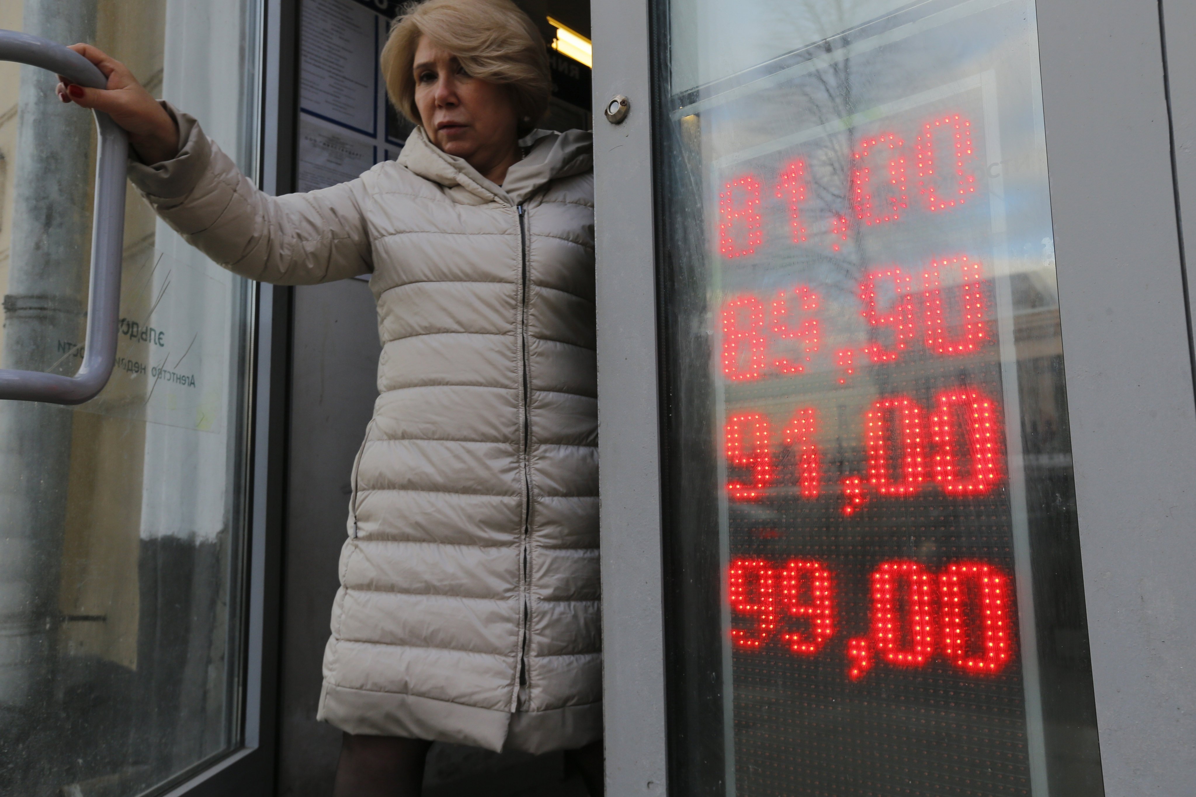 A woman leaves an exchange office showing the rates of the US Dollar and Euro to Russian Roubles in Moscow. The Kremlin admitted the country’s economy was in ruins last year after it was sanctioned for invading Ukraine. Photo: AP