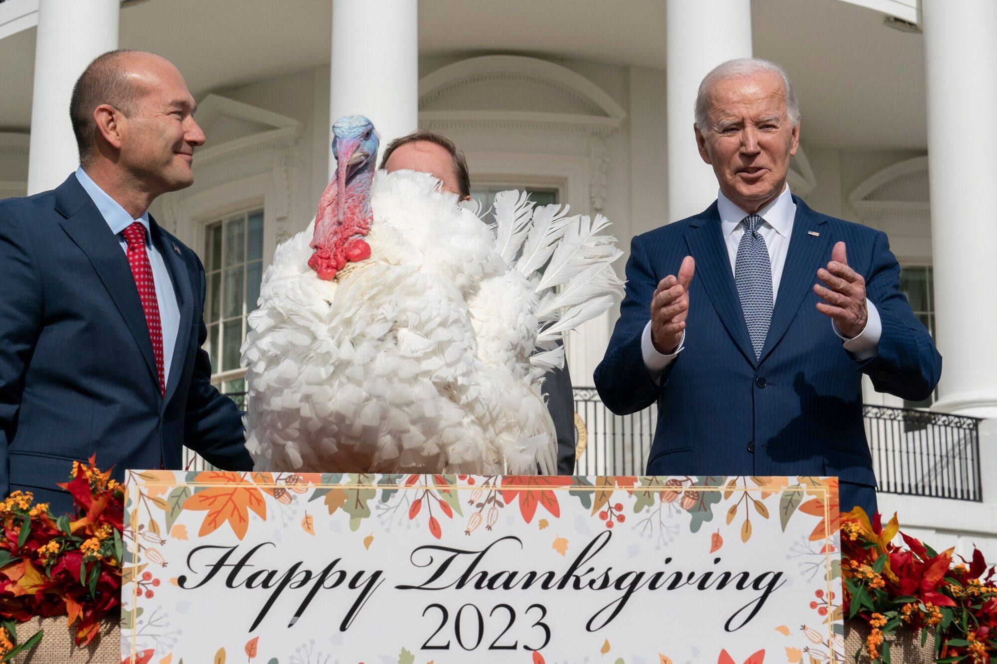 US President Joe Biden pardons the National Thanksgiving Turkey, Liberty, during a ceremony with Jose Rojas, assistant vice president of live production at the Jennie-O Turkey Store, left, on the South Lawn of the White House in Washington on Monday. Photo: CNP / Bloomberg