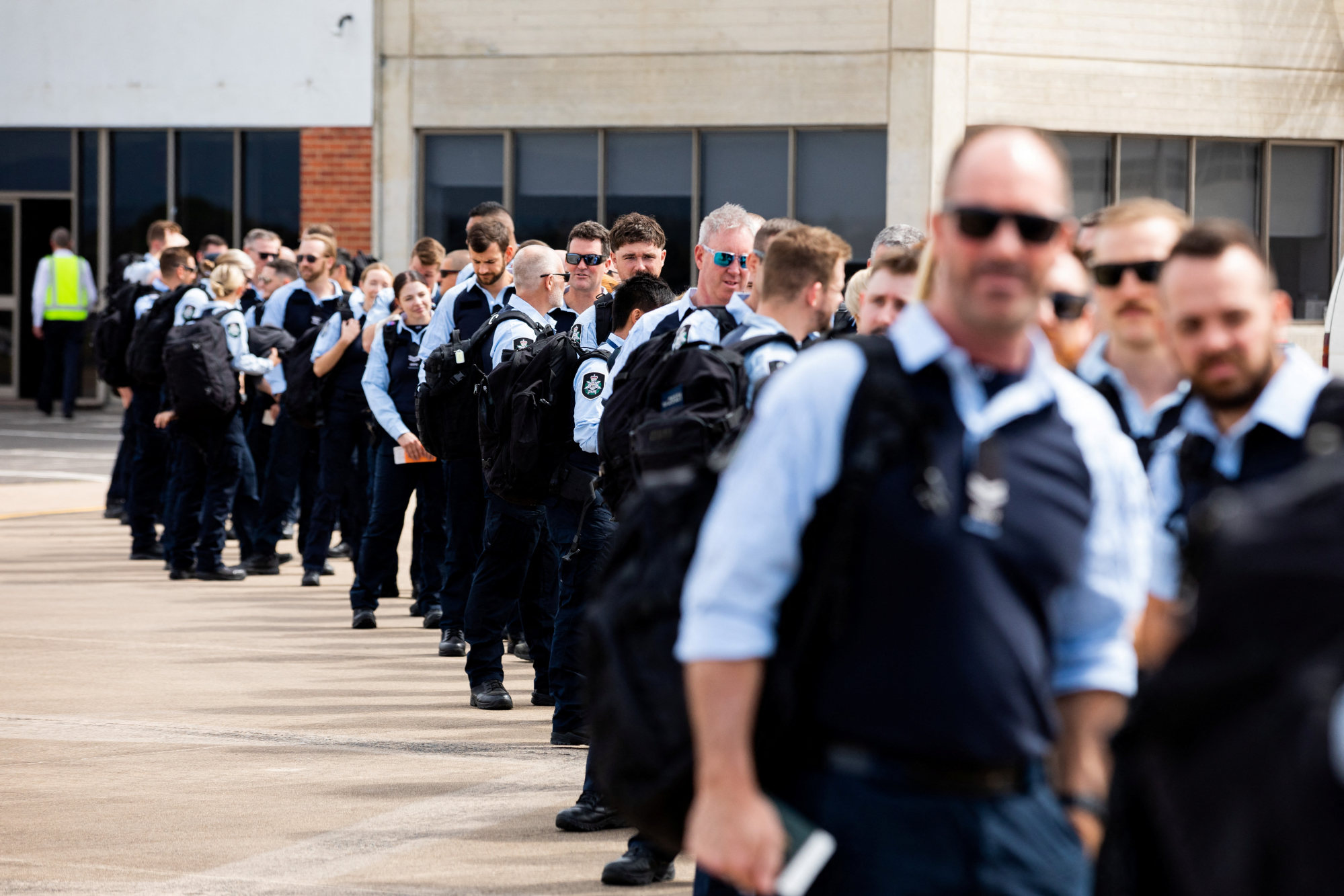 Members of the Australian Federal Police board a flight to the Solomon Islands to support the Royal Solomon Islands Police Force ahead of the Pacific Games, in Australia on November 8. Photo: Australian Federal Police/Handout via Reuters