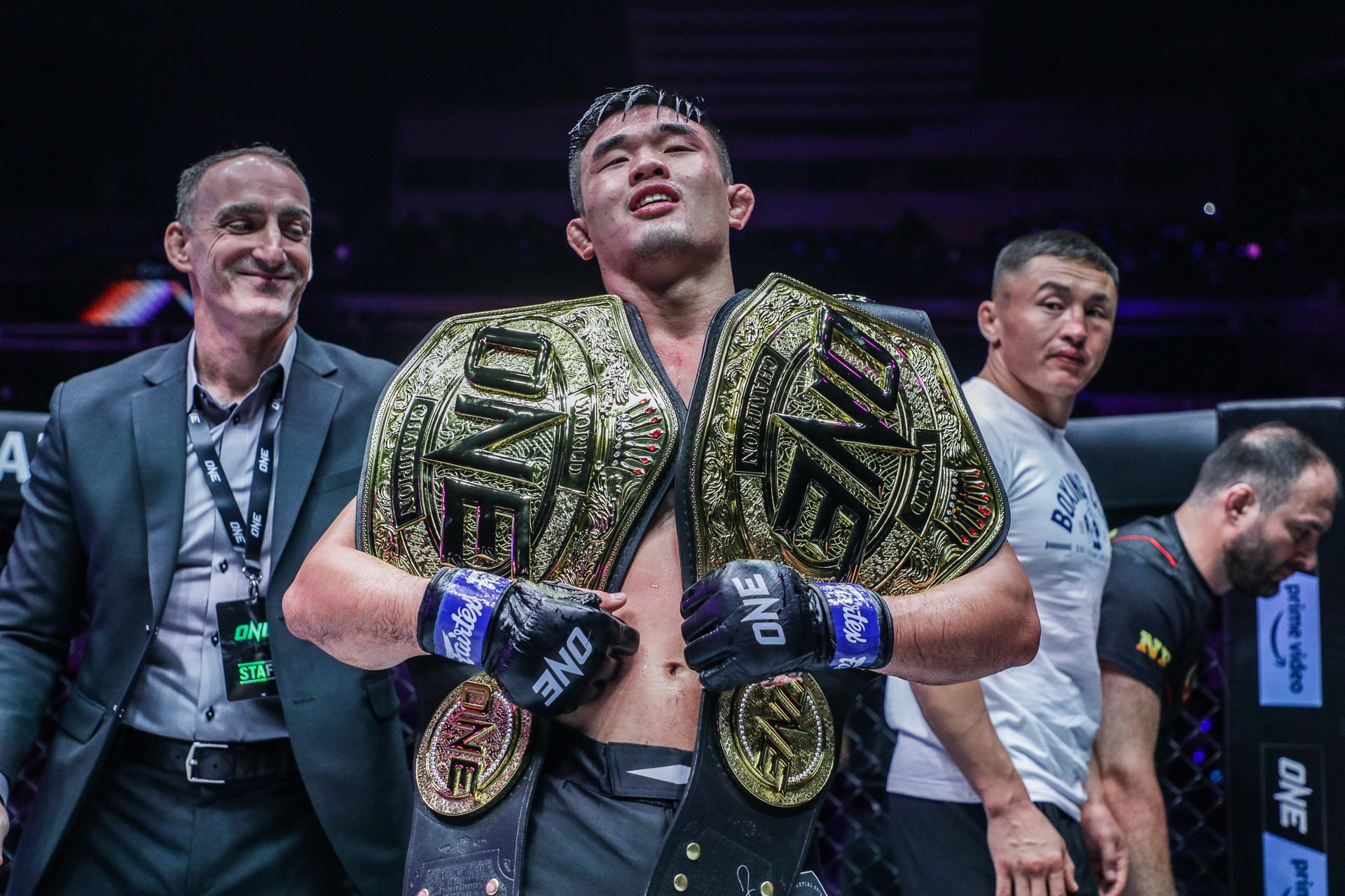 Christian Lee holds his two ONE Championship title belts after beating Kiamrian Abbasov in November 2022. Photos: ONE Championship