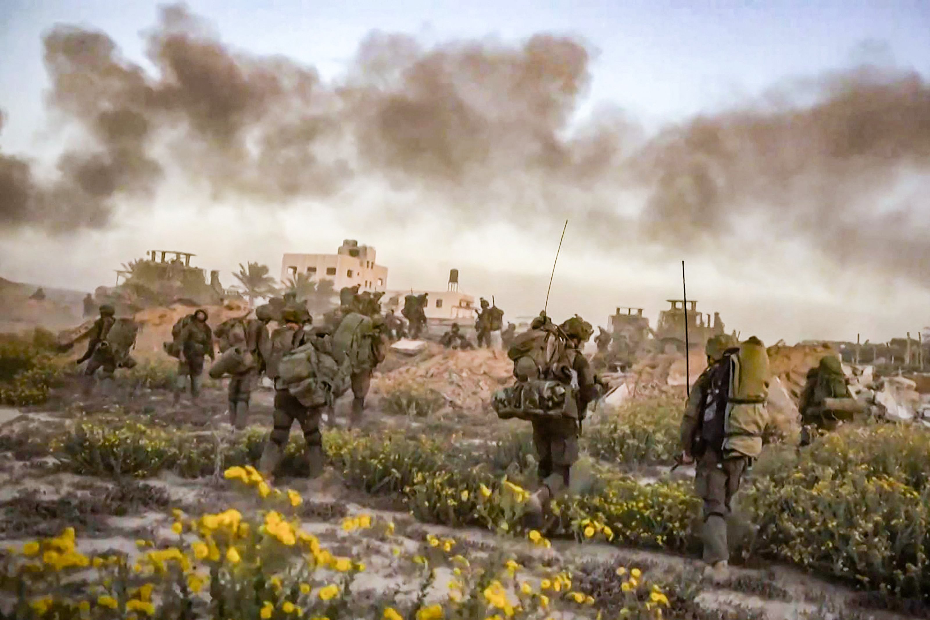 Smoke rises as Israeli forces patrol inside the Gaza Strip, in a still from a video released by the Israeli army on November 11. Photo: AFP