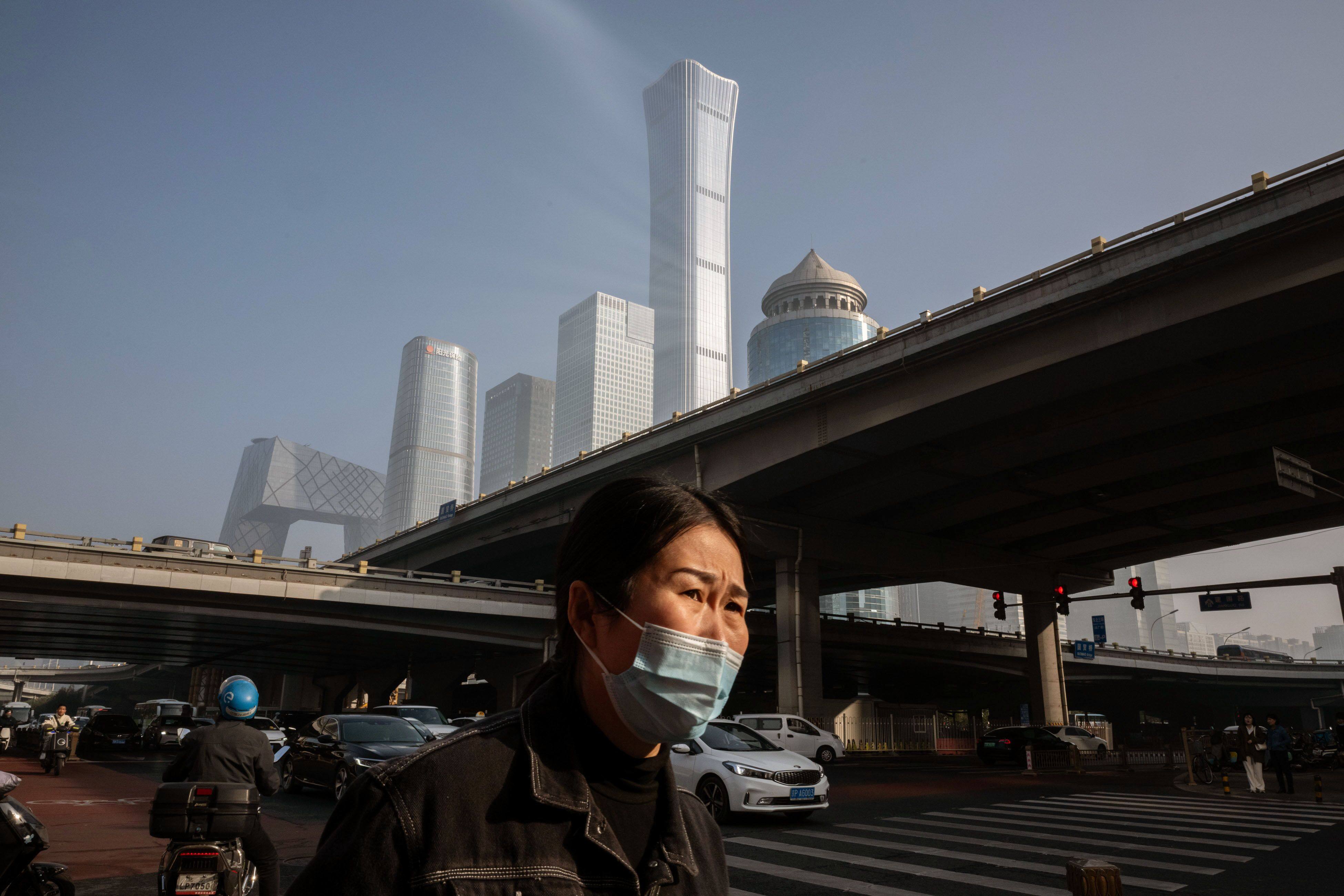 A morning commuter in the central business district in Beijing, China. Photo: Bloomberg
