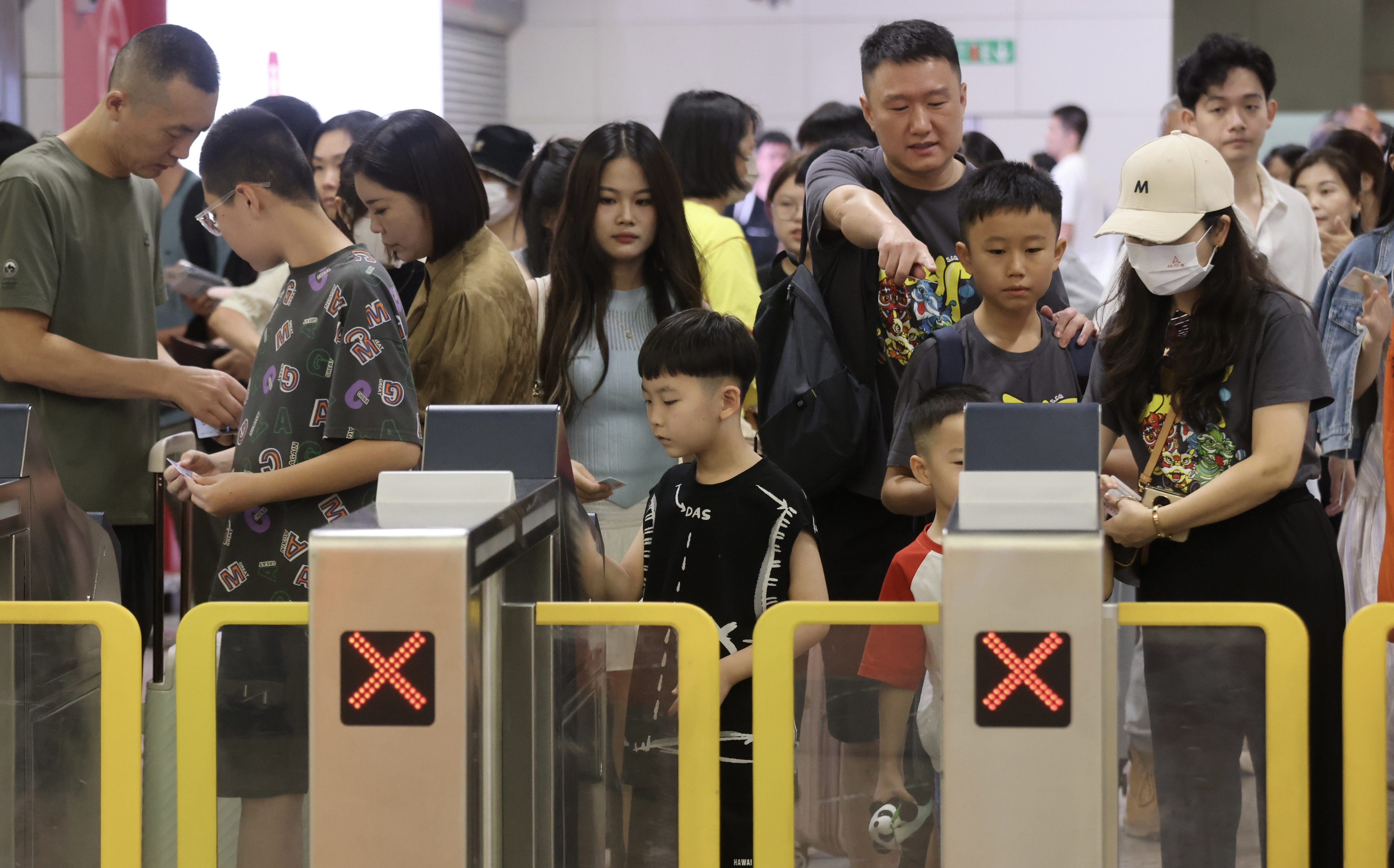 Travellers pass through gates at Hong Kong’s West Kowloon station. The high-speed rail link currently connects the city to 73 mainland destinations. Photo: Jonathan Wong