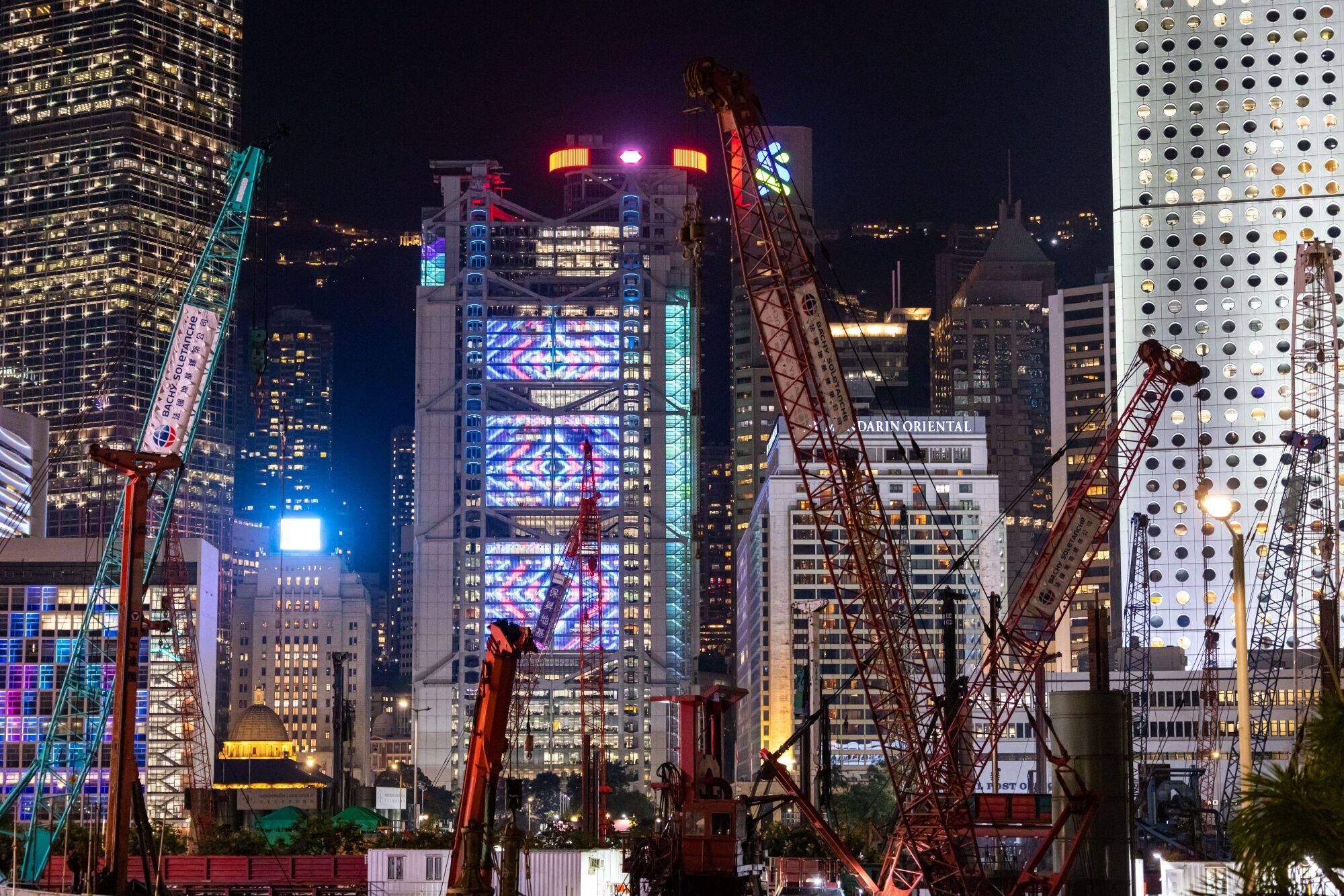 Illuminated office buildings in the Central district in Hong Kong seen on November 20. Companies should address the problems that Hong Kong people have been complaining about – excessive air-conditioning and lighting. Photo: Bloomberg