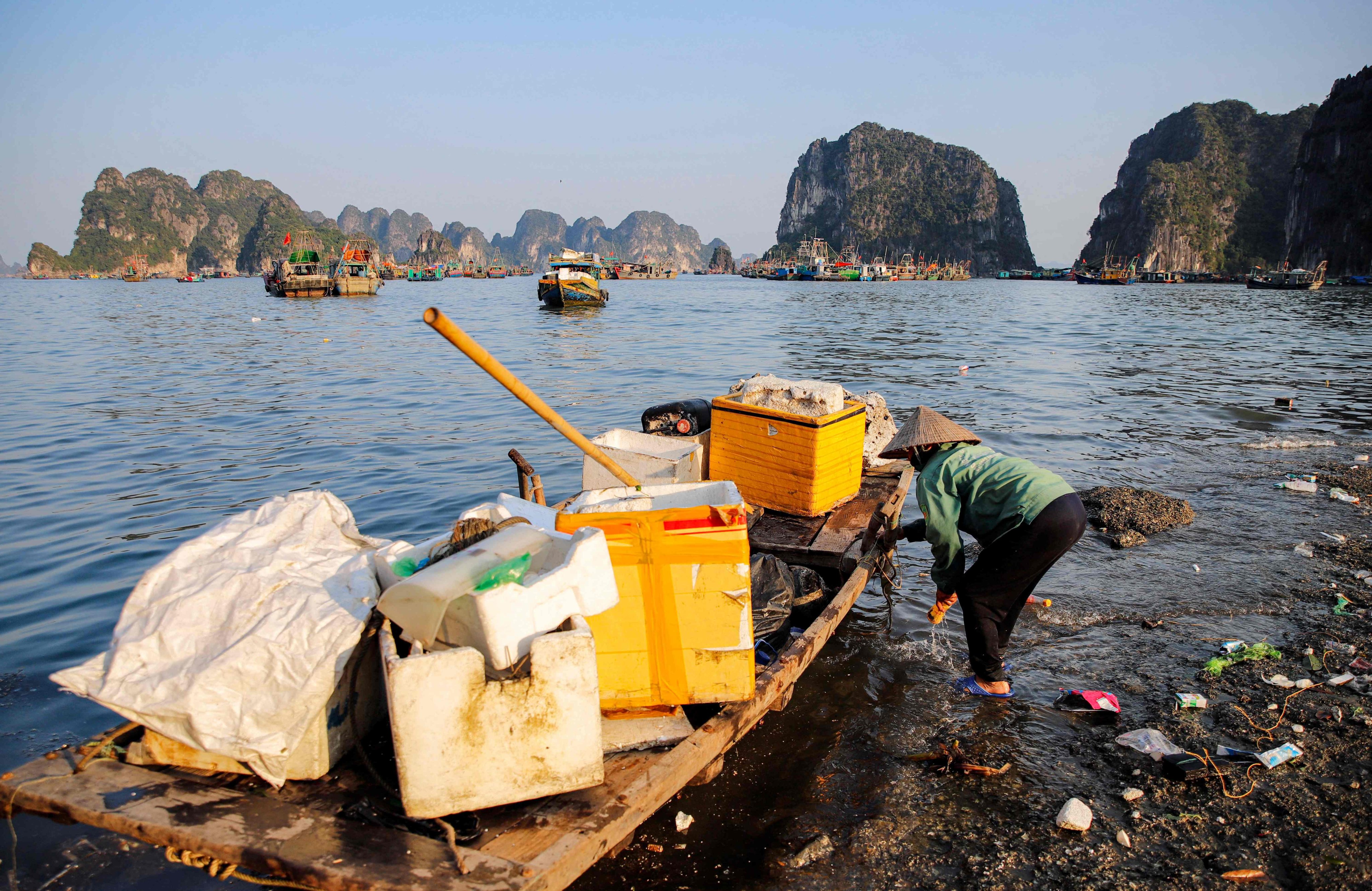 A worker picks up trash, including plastic, from Ha Long Bay in northeast Vietnam. The country is the world’s fourth largest emitter of marine plastic pollution. Photo: AFP