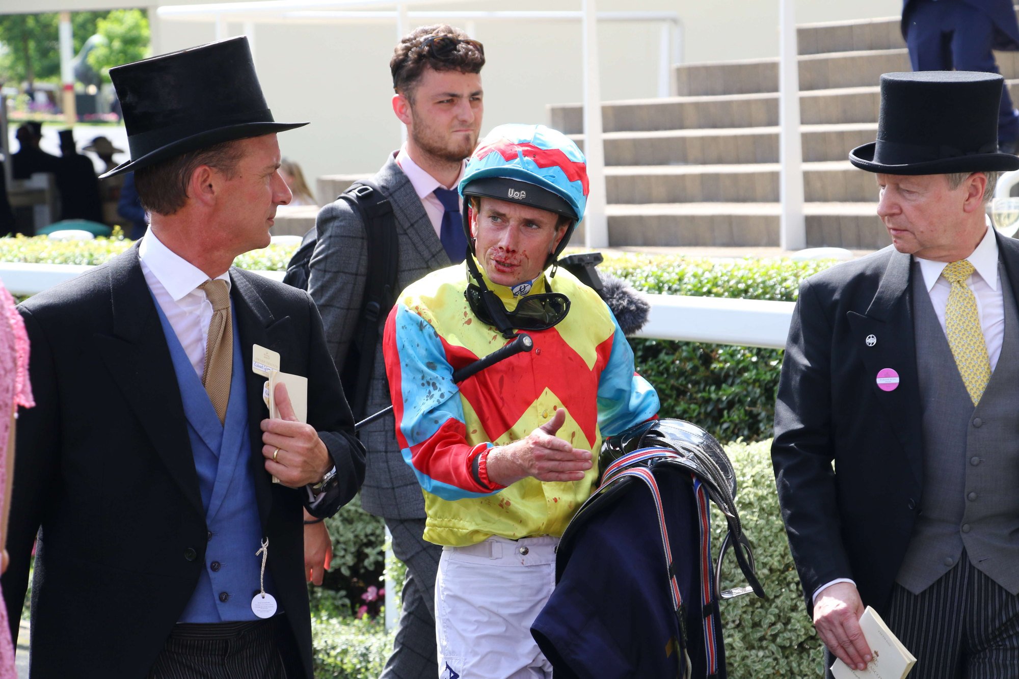 A bloodied Ryan Moore discusses Wellington’s Royal Ascot effort with trainer Richard Gibson (left) and Jockey Club chief executive Winfried Engelbrecht-Bresges.