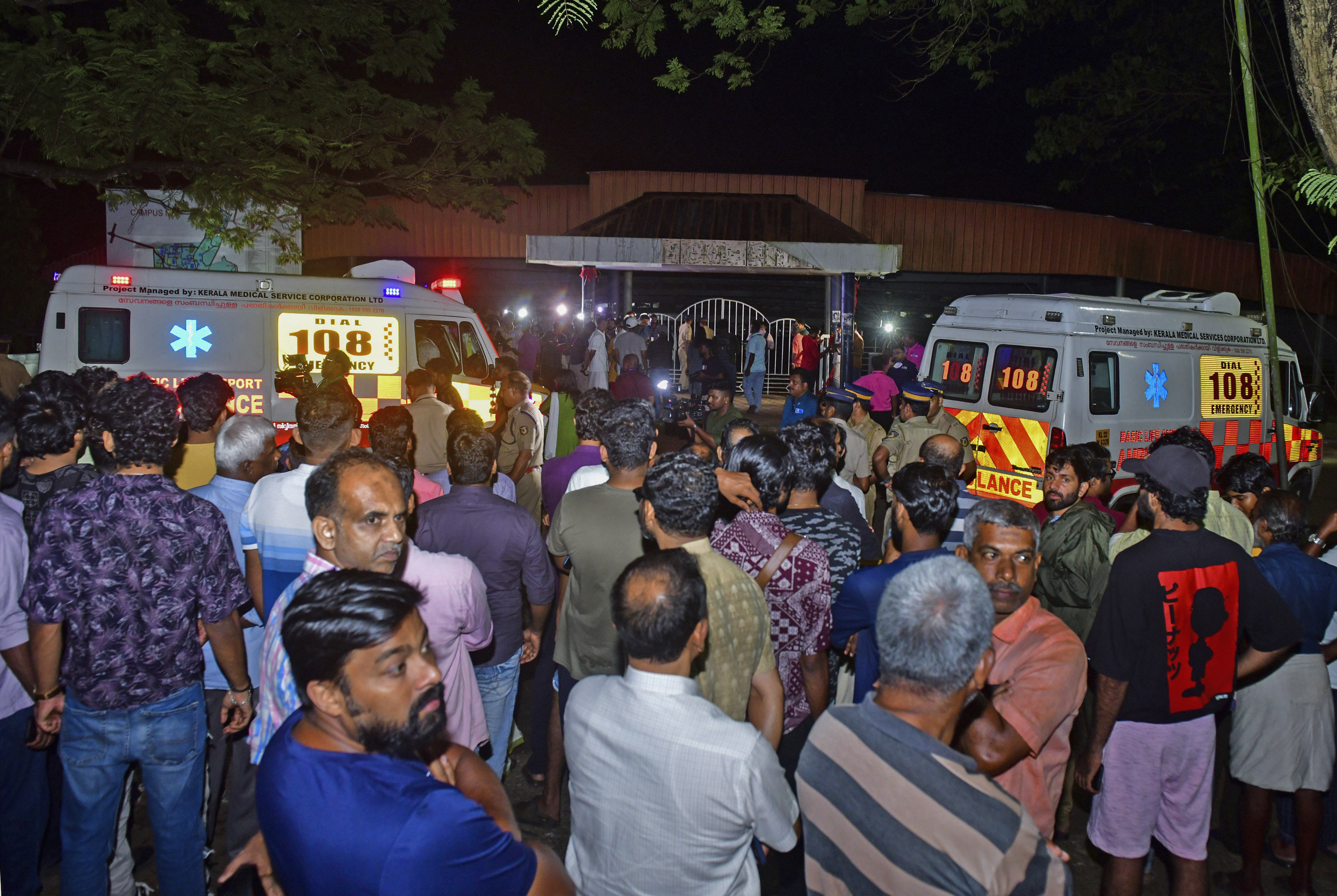 People gather outside the venue after a stampede at a music concert at the Cochin University of Science and Technology in Kerala state, India on Saturday. Four people died and dozens of students were injured in the incident. Photo: AP
