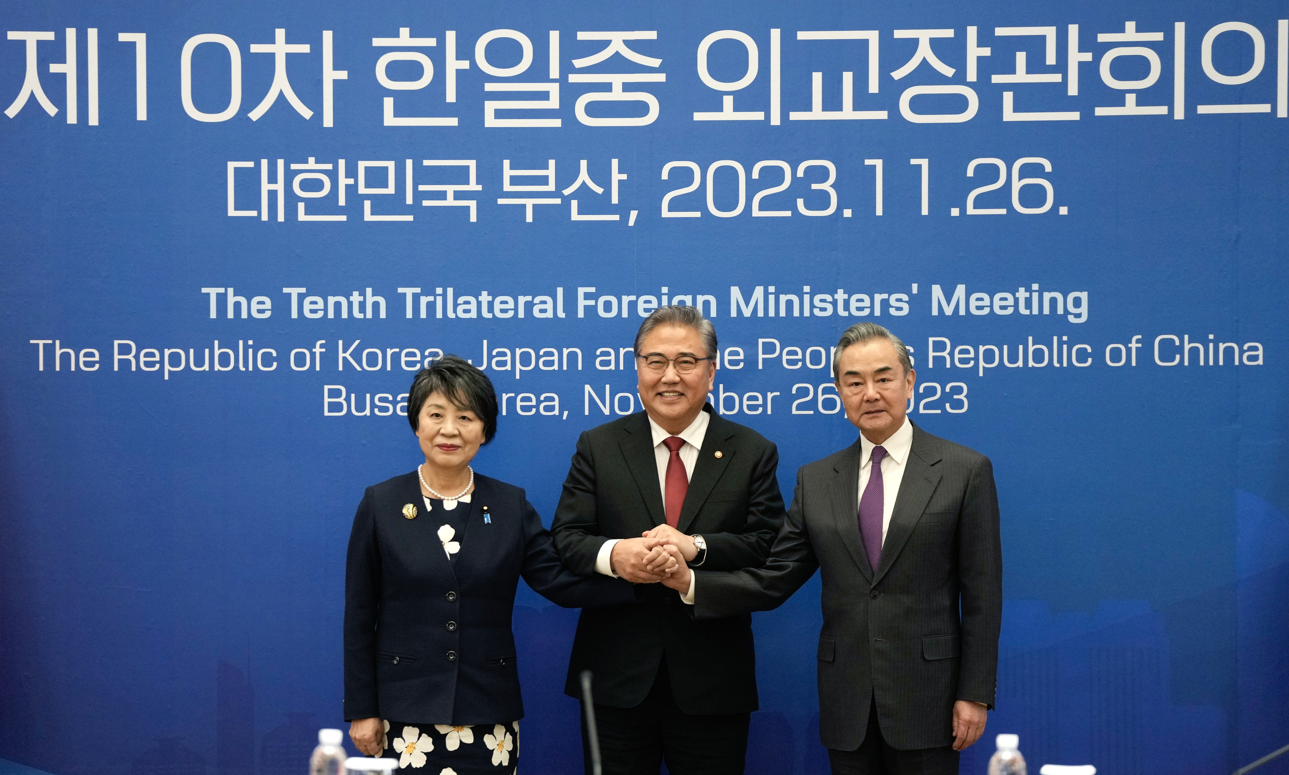 Japan’s Yoko Kamikawa and China’s Wang Yi with their South Korean counterpart, Foreign Minister Park Jin, ahead of their meeting in   Busan, South Korea, on Sunday. Photo: EPA-EFE 