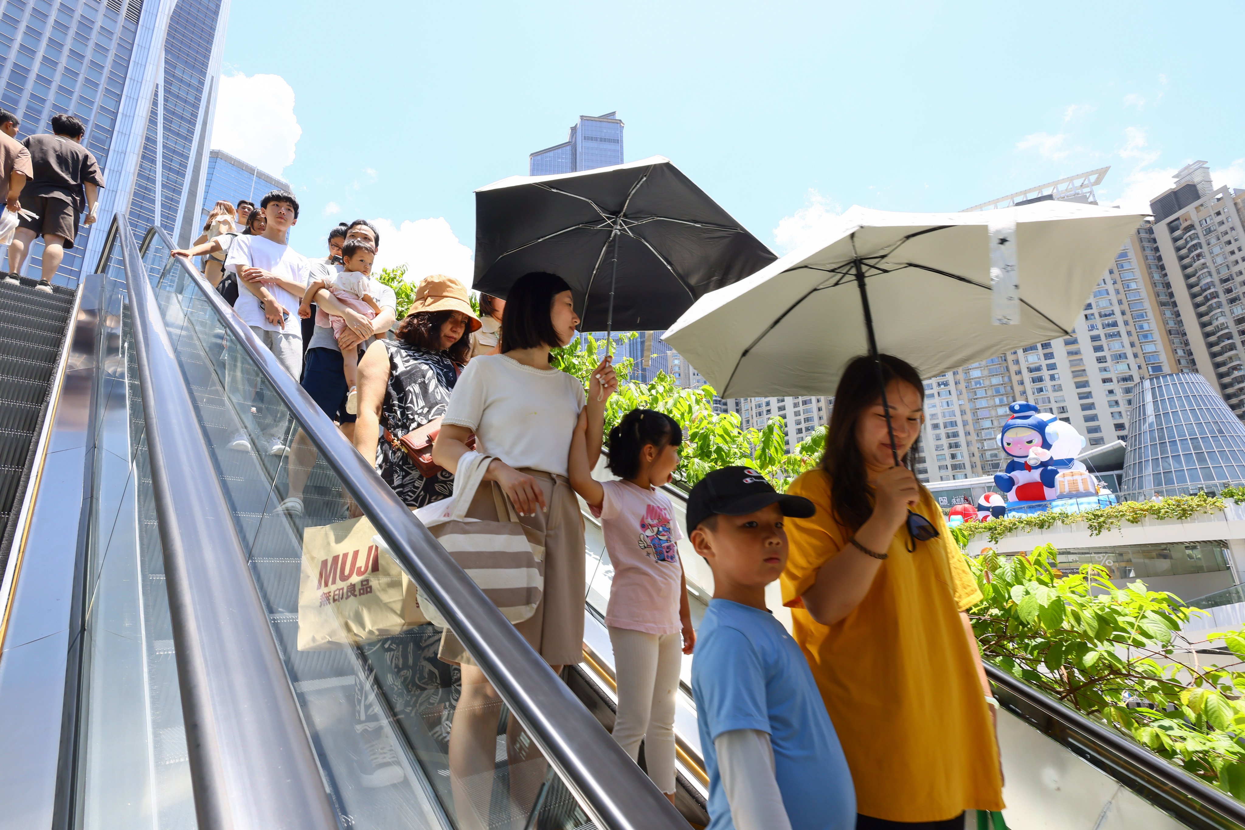 Families are seen in Coco Park, a retail and lifestyle complex in Shenzhen, on August 6. To attract talent, the Hong Kong government must make it easy for professionals in Shenzhen to access quality health and education services in Hong Kong. Photo: Dickson Lee 