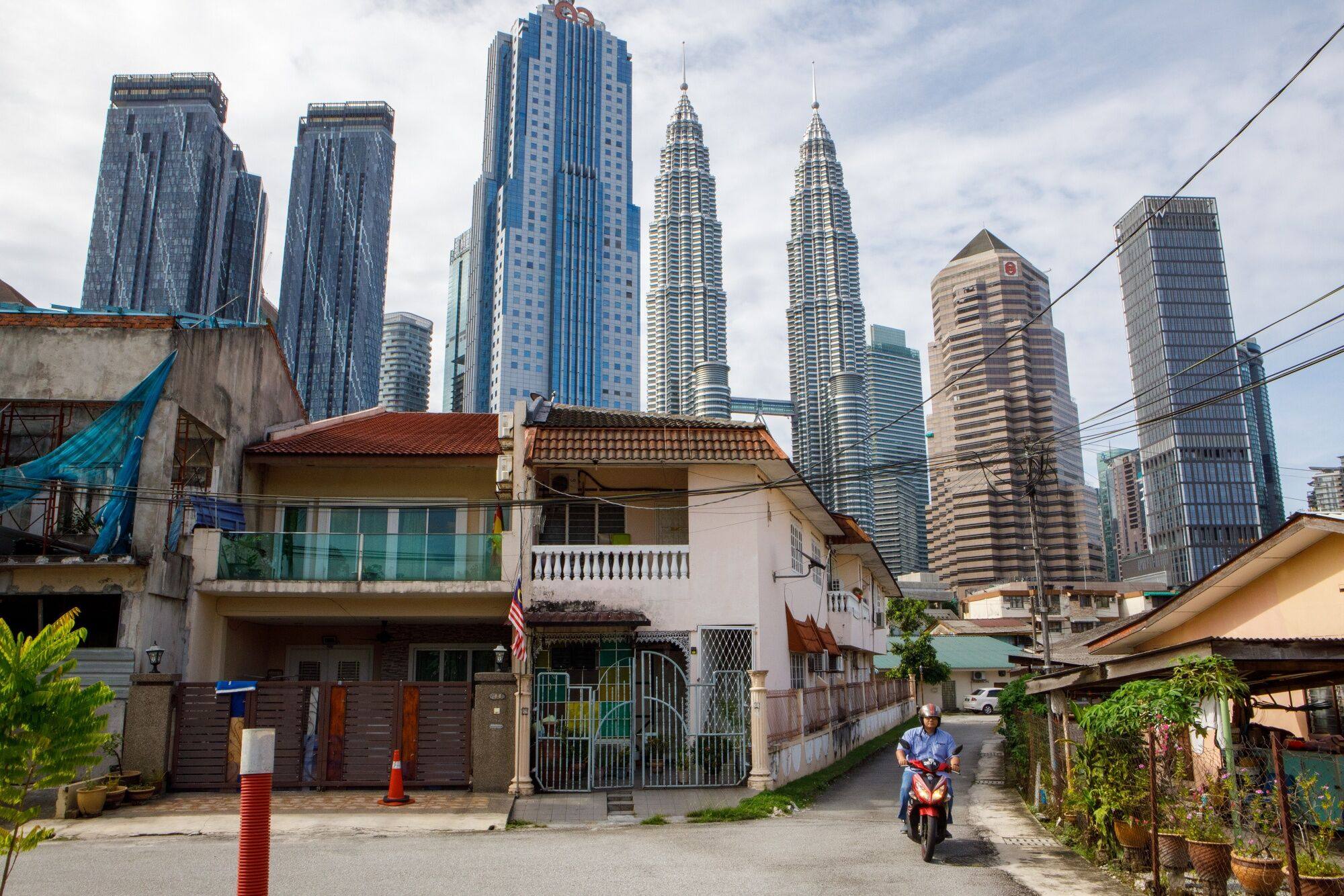 The Petronas Twin Towers beyond a residential area in Kuala Lumpur. In 2019, more than 3.1 million Chinese visited Malaysia, the third largest group behind Singapore and Indonesia. Photo: Bloomberg