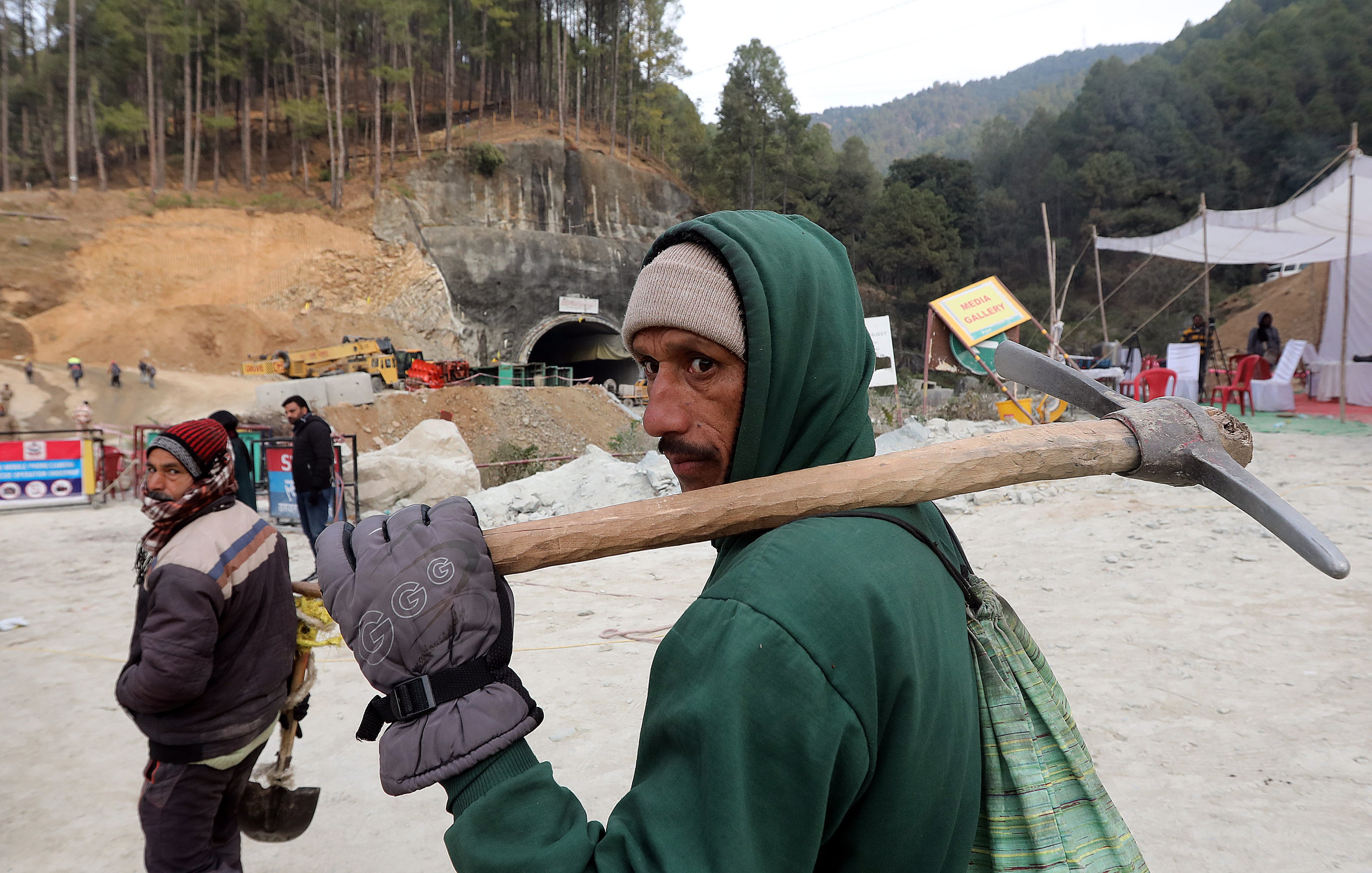 A worker arrives at the site of the Silkyara tunnel that collapsed while being under construction, to join in rescue operations, in Uttarkashi, India. Photo: EPA-EFE