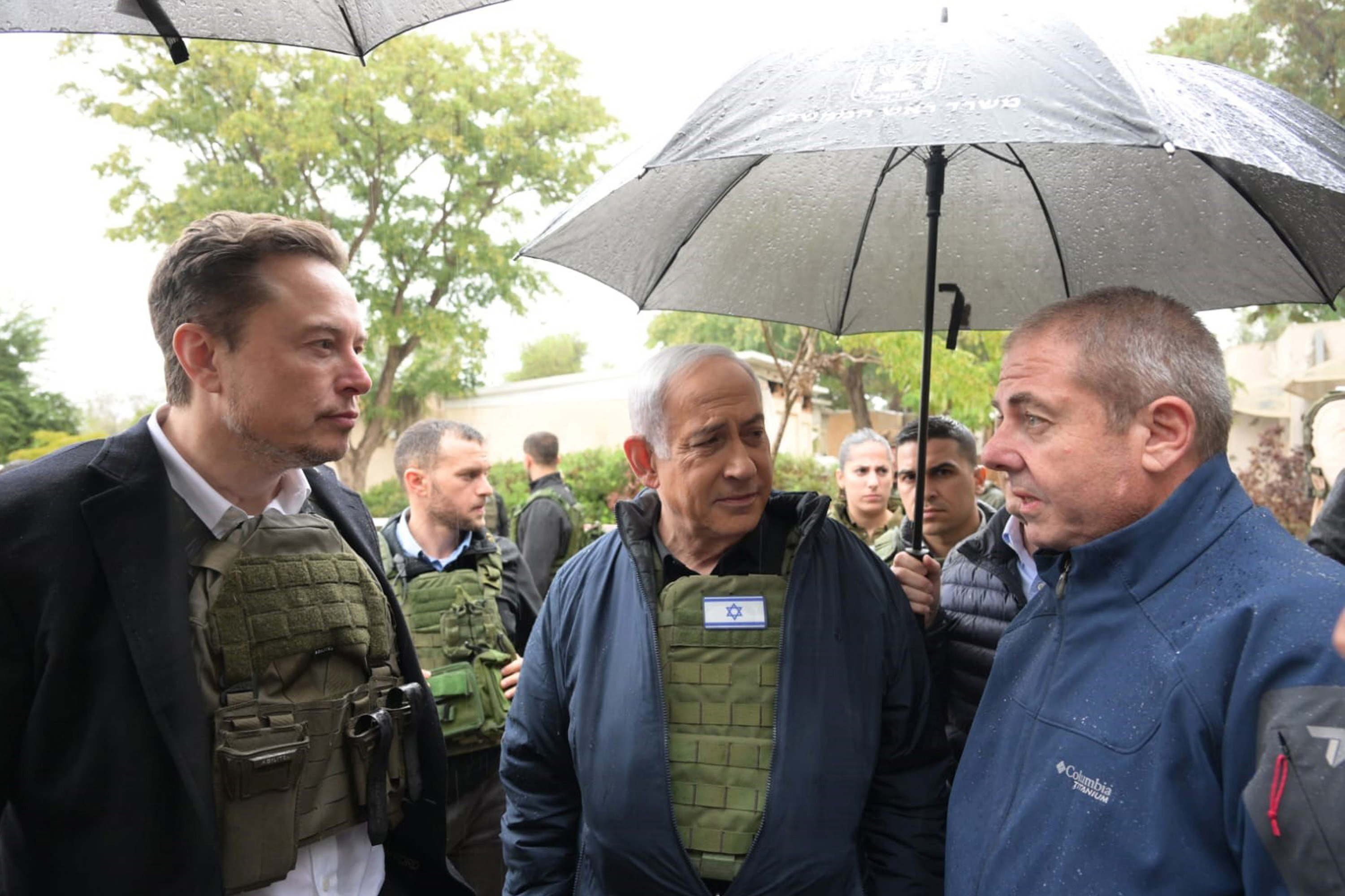 Israel’s Prime Minister Benjamin Netanyahu, centre, takes billionaire Elon Musk, left, on a tour of Kibbutz Kfar Aza in Israel on Monday. Photo: Amos Ben-Gershom (GPO) Handout via Getty Images / TNS