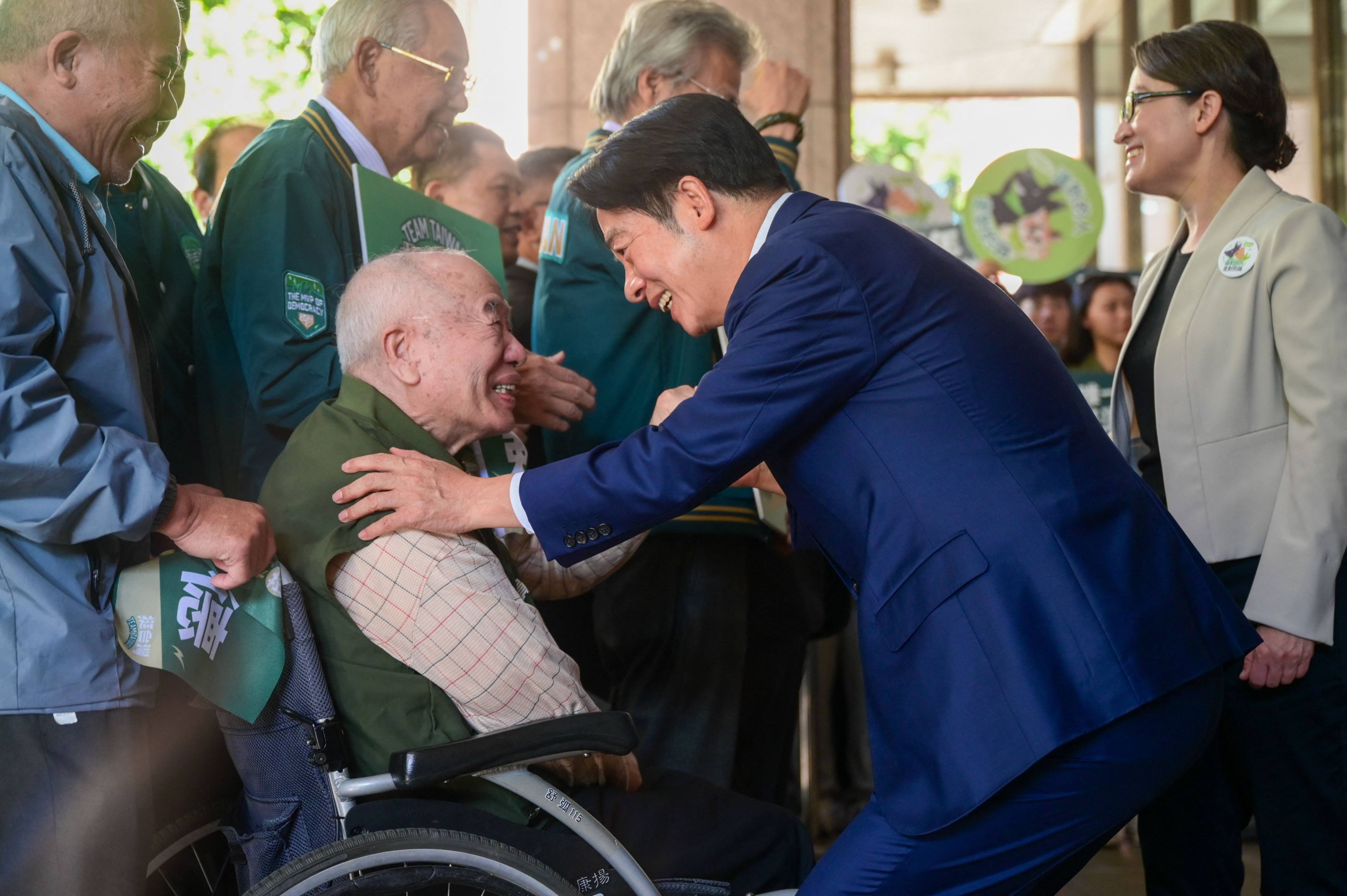 Taiwanese presidential candidate William Lai shakes hands with a supporter in Taipei, after registering for the election, on November 21. Photo: AFP