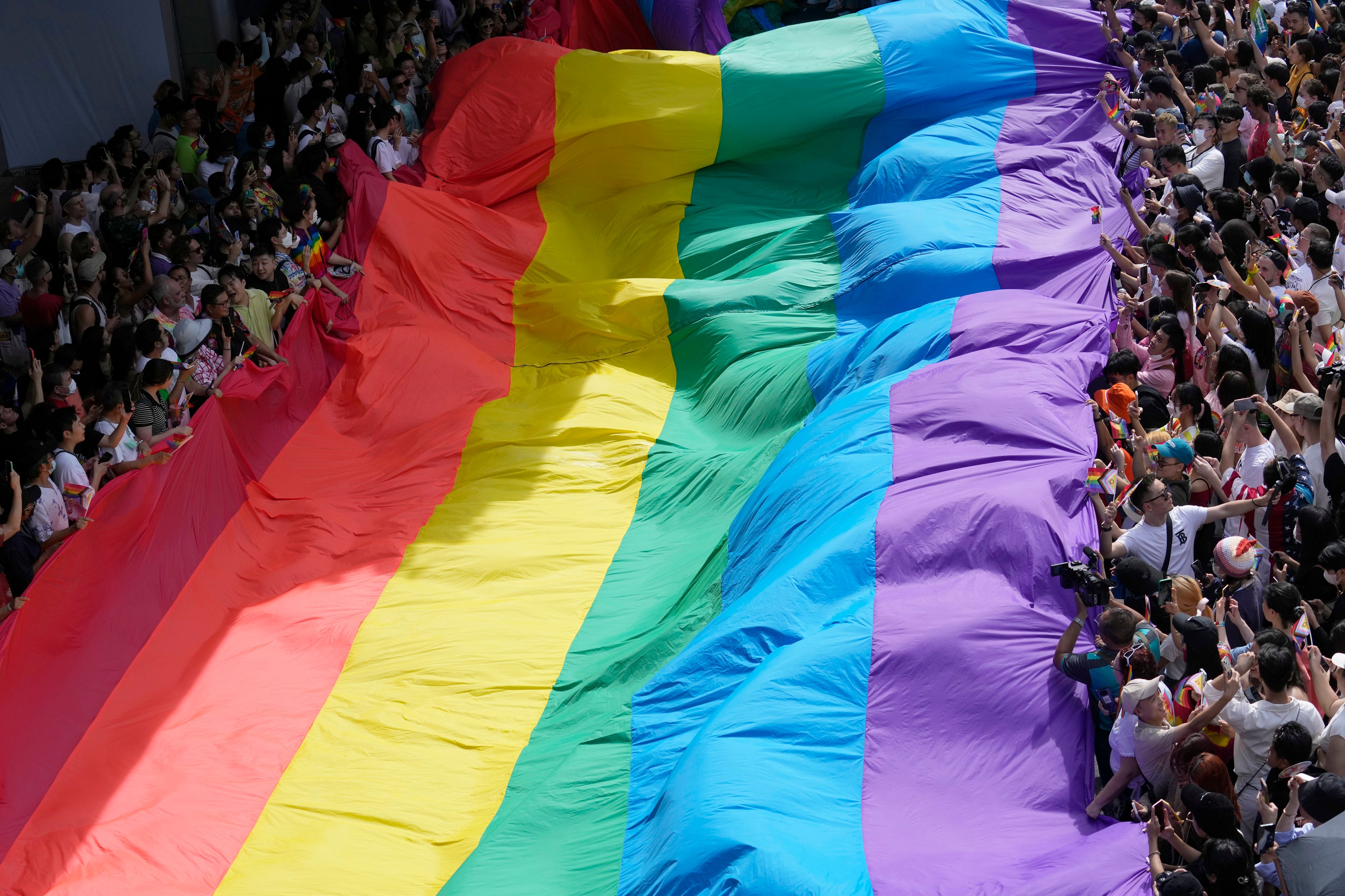 Participants of a Pride Parade in Bangkok, Thailand, on June 4 hold a rainbow flag. Thailand will soon join the ranks of countries and regions who have made same-sex marriage legal. Photo: AP
