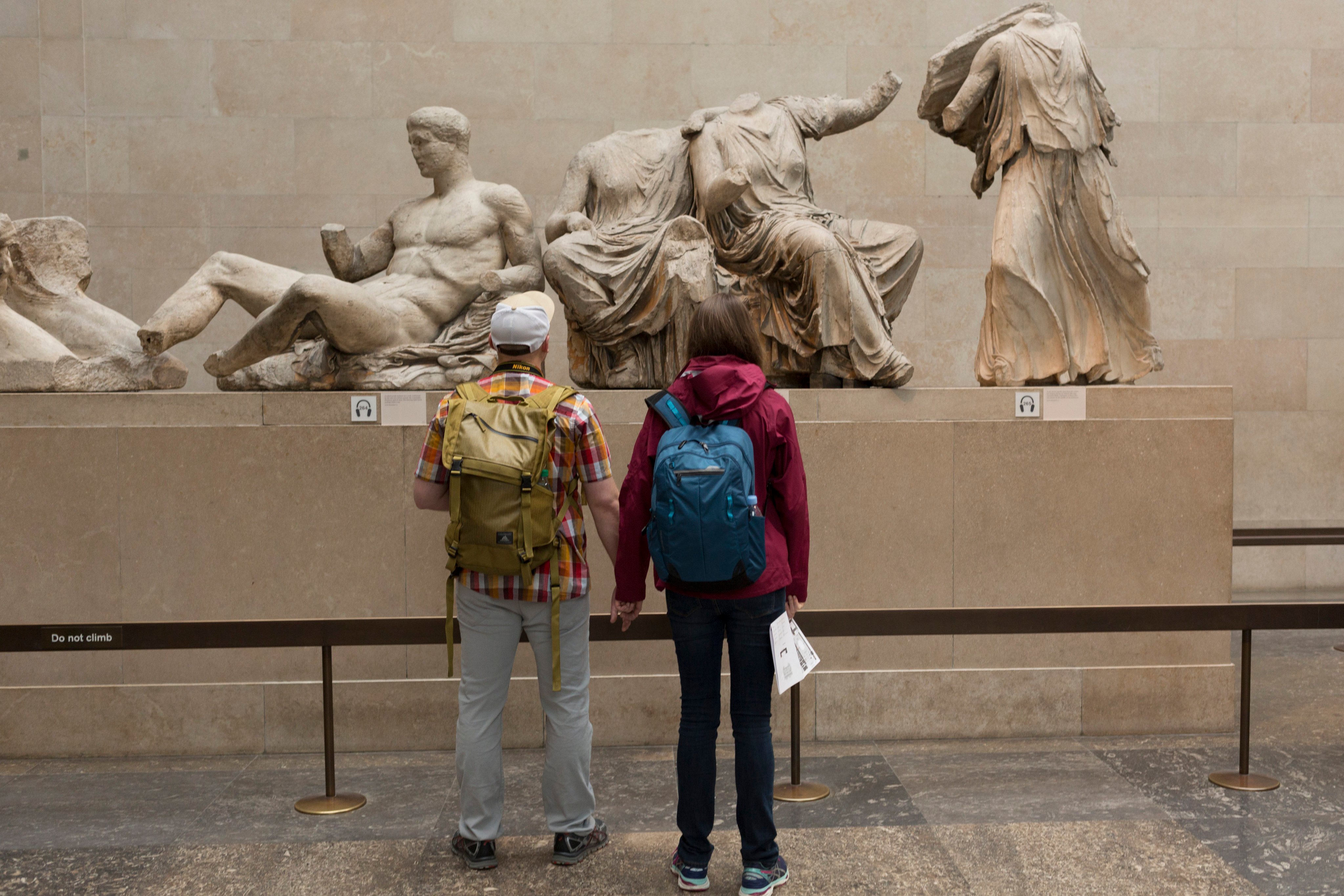 Visitors admire the ancient Greek Parthenon’s Elgin Marbles Metopes in the British Museum. Photo: Getty Images
