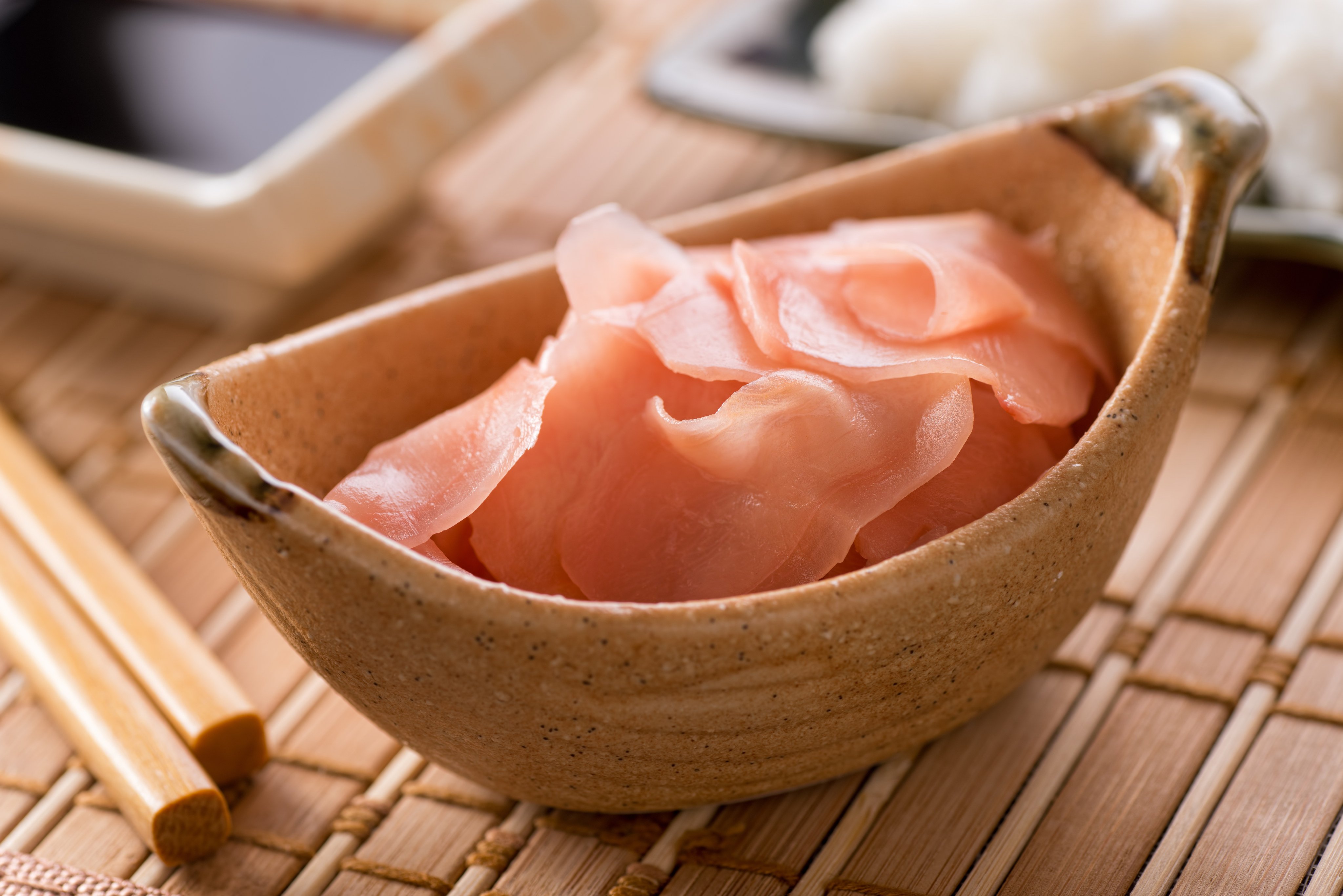 Pickled ginger slices are typically served to accompany sushi. Raw ginger benefits health in a variety of ways, and some, but not all, of these are preserved when the root is pickled. Shutterstock Images